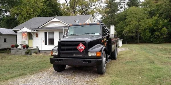 A black truck is parked in front of a house.