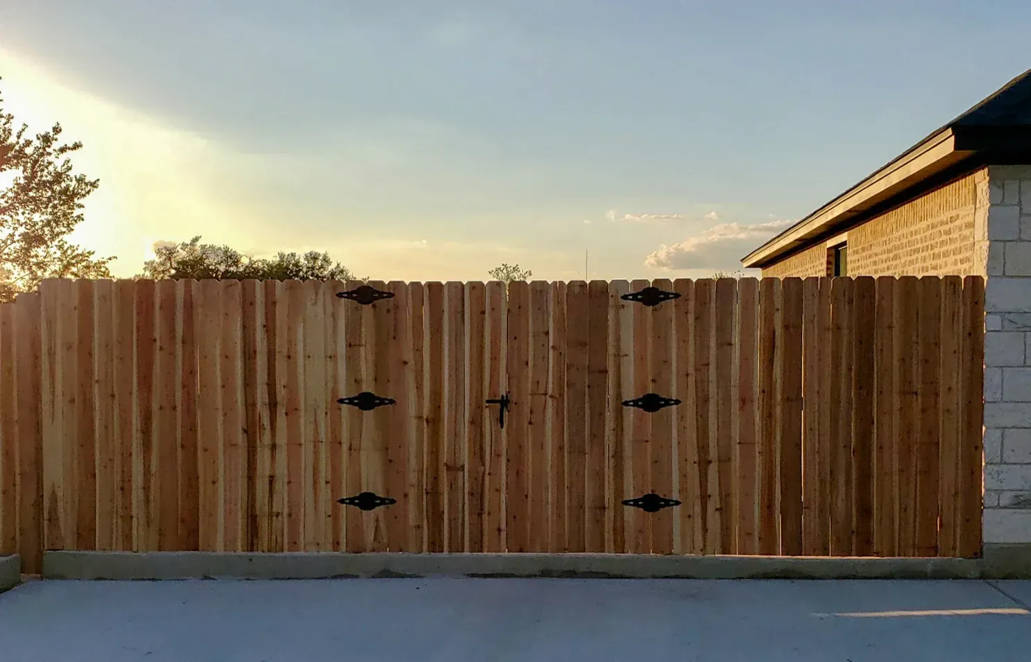 Wooden fence with decorative black hardware; 