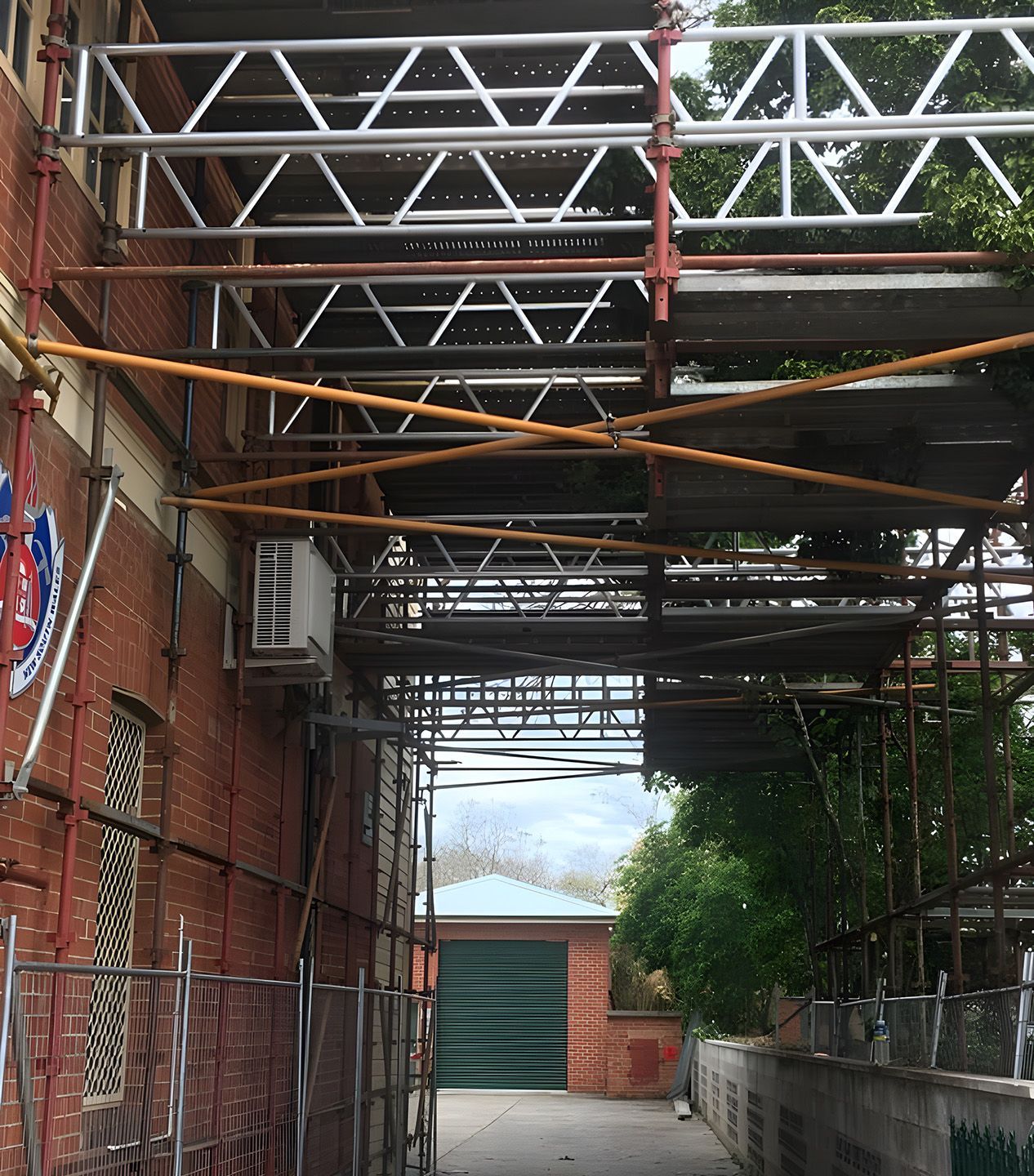 Building Access Scaffolding Installed Over Narrow Walkway