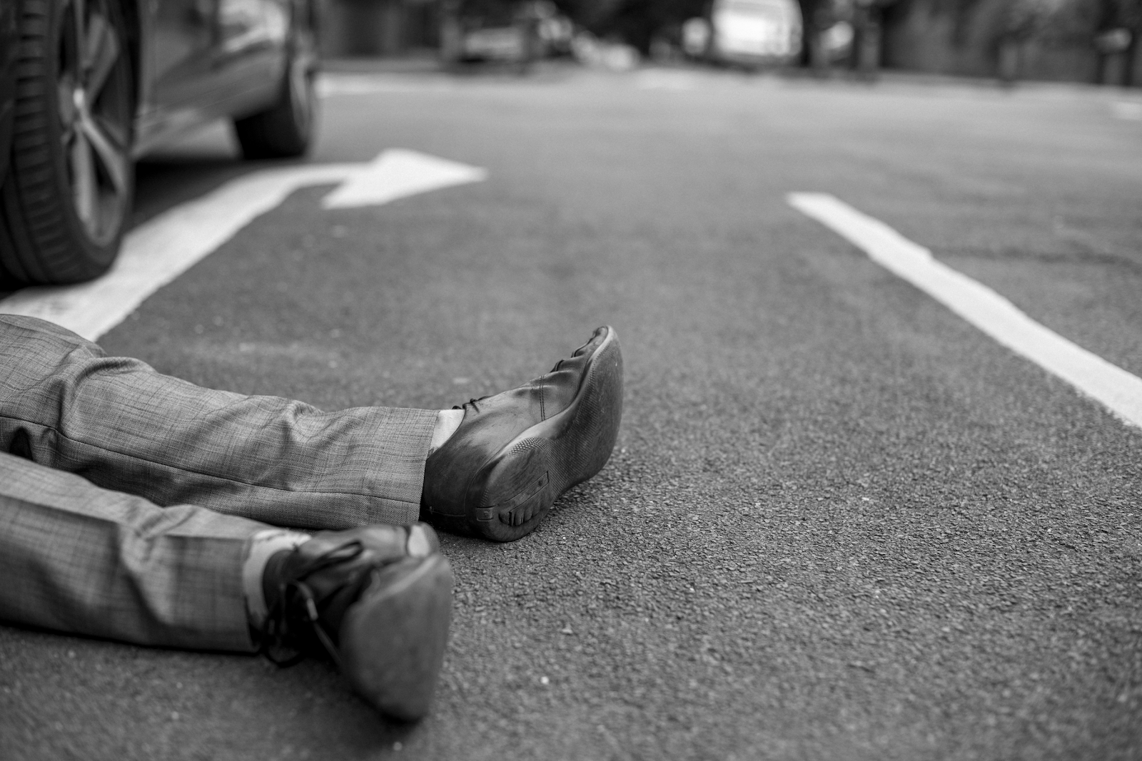 man laying on street