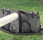 A lawn mower is sitting on top of a grass covered field.