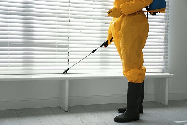 Male Worker in Protective Suit Spraying Insecticide — North Fort Myers, FL — My Pest Friend