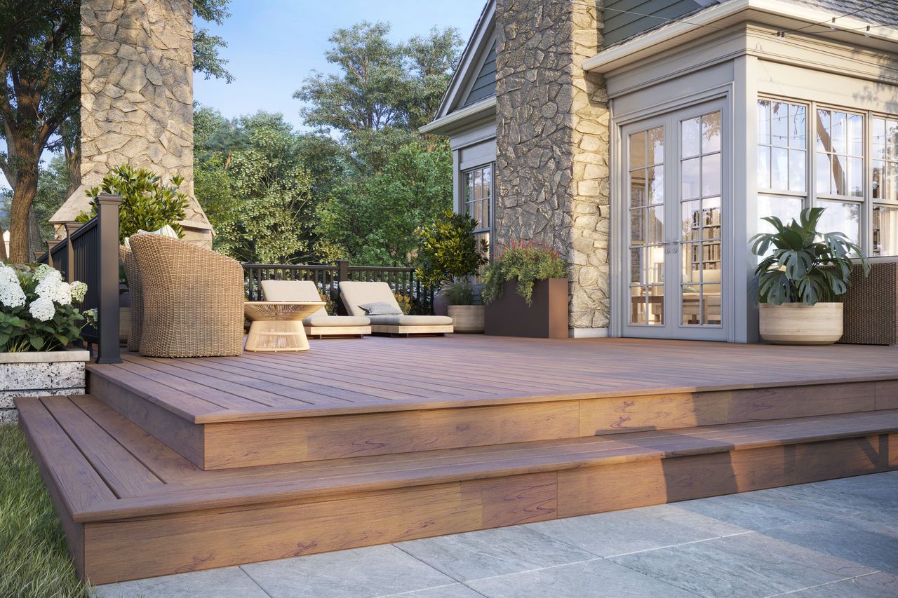A man is working on the roof of a house next to a truck that says ' roofing ' on it
