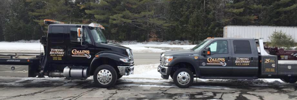 two towing trucks are parked next to each other on a snowy road | Collins Enterprises