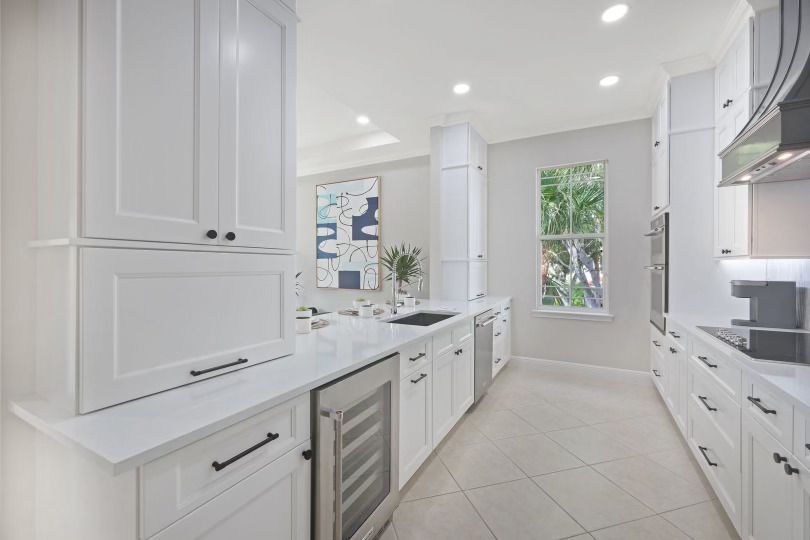 A kitchen with white cabinets and stainless steel appliances.