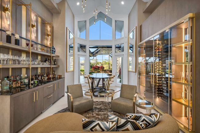 A living room filled with furniture and a bar.
