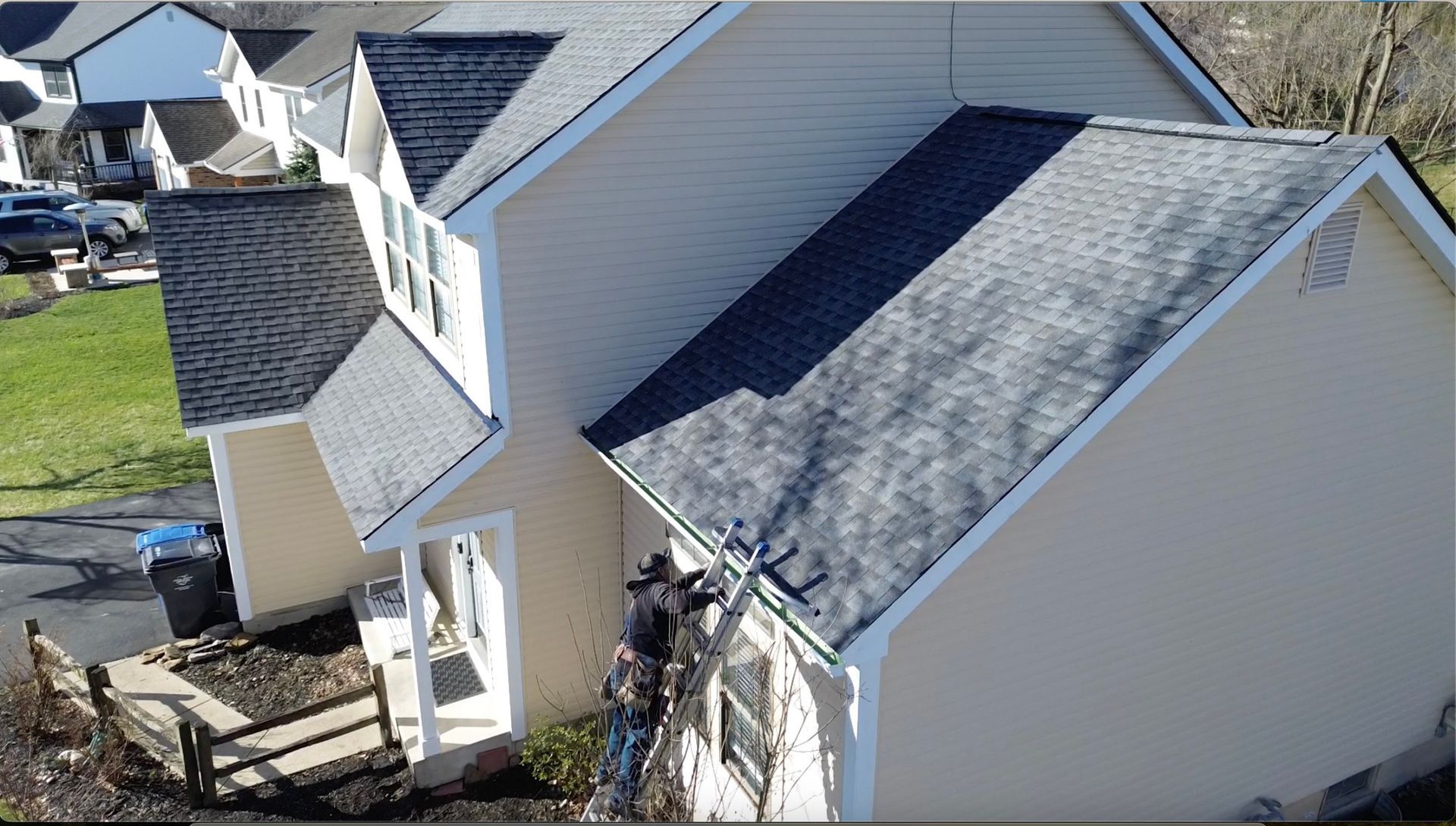 A roof with a lot of shingles and trees in the background.