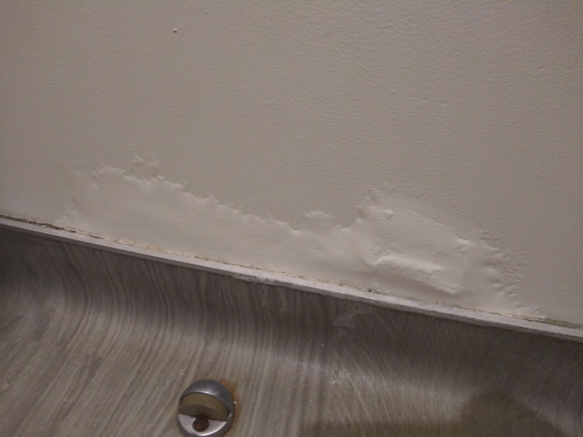 A close up of a bathroom sink with a hole in the floor.