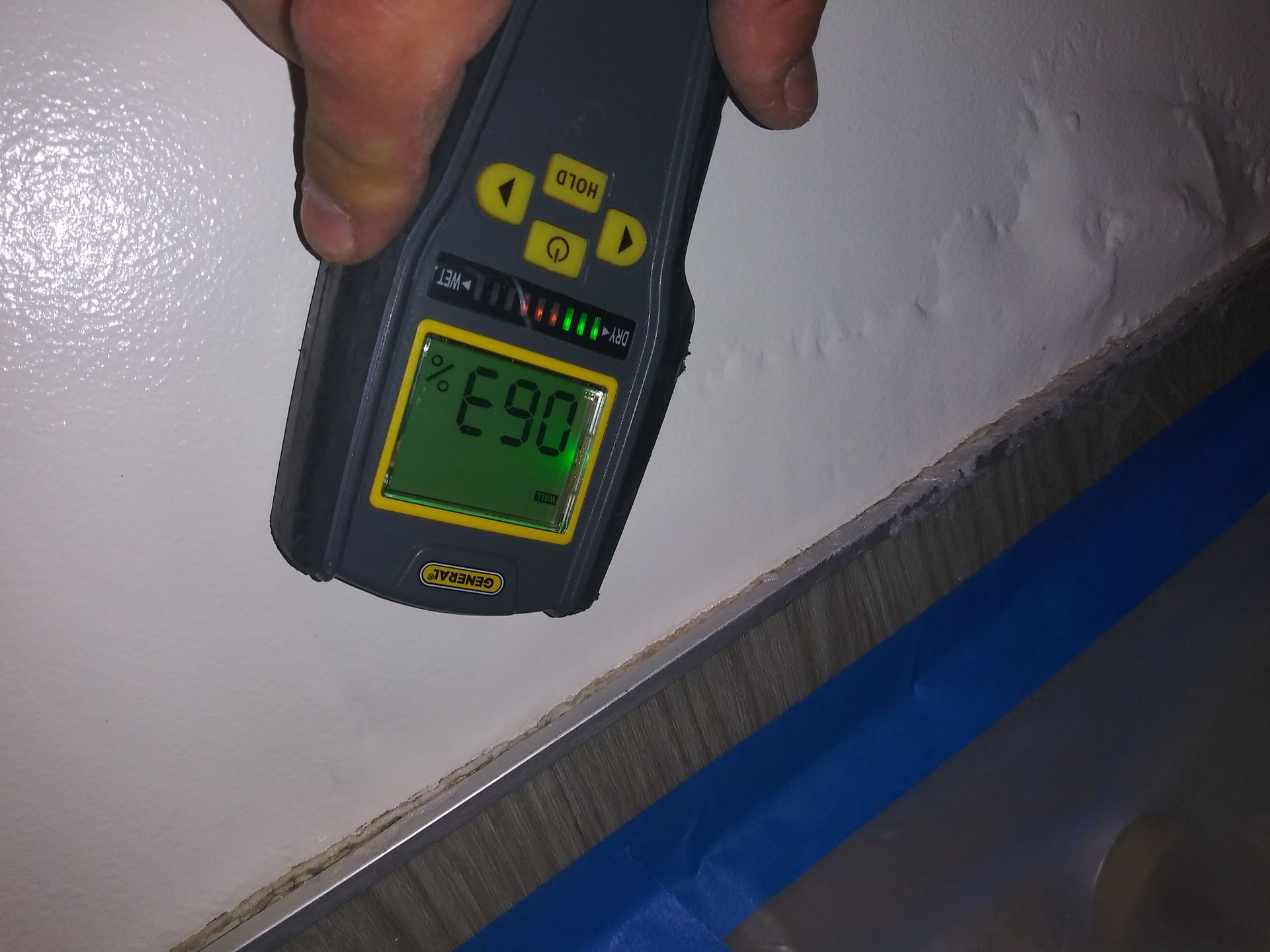 A person is holding a device that says e90 on the screen