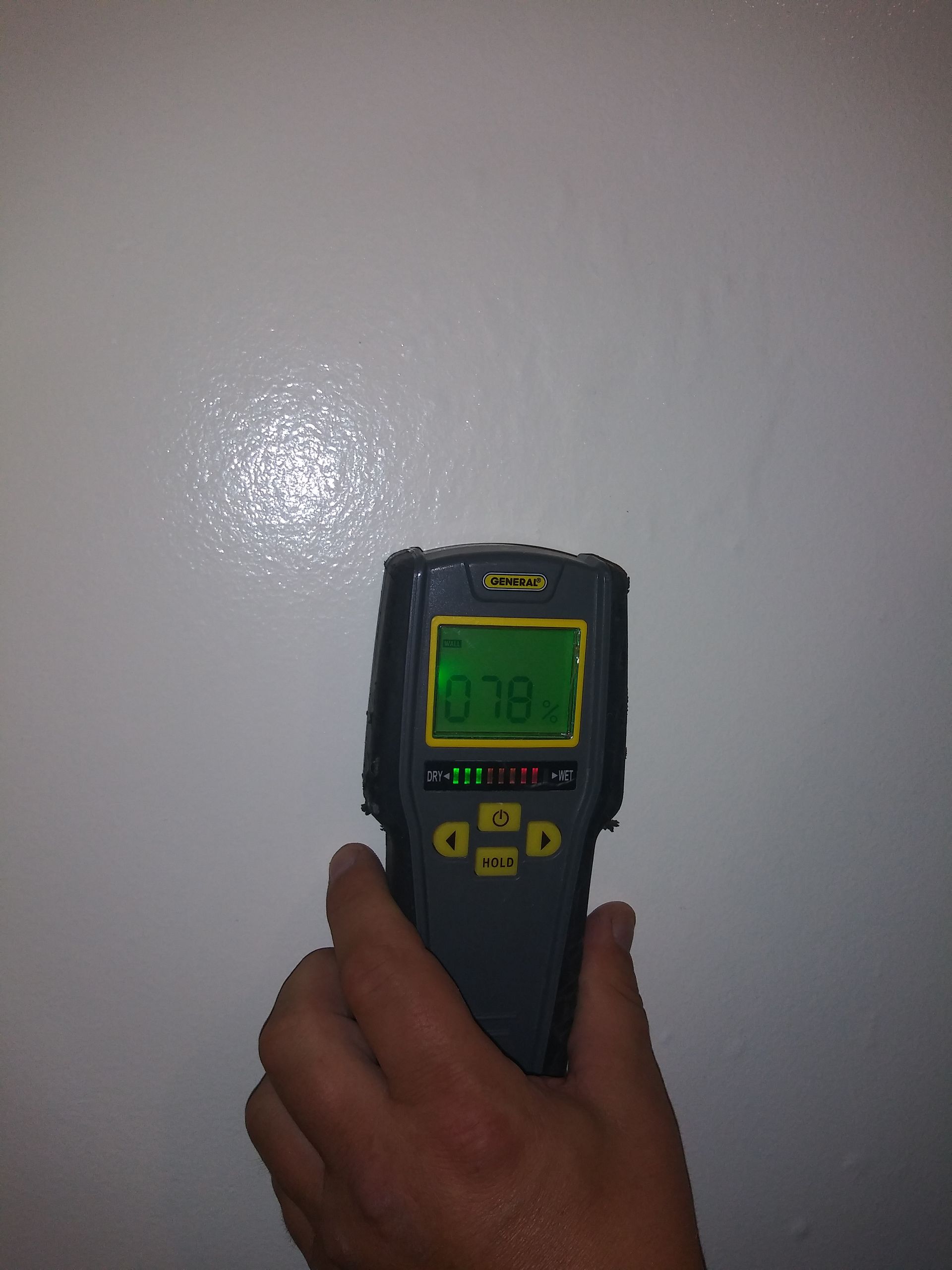 A person is holding a device that says 0.38 on the screen