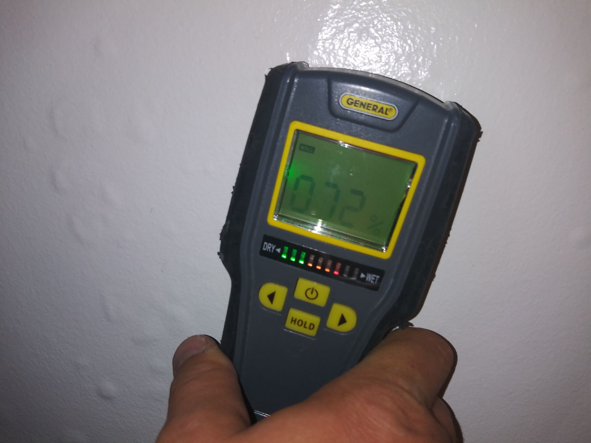 A person is holding a device that says 032 on the screen