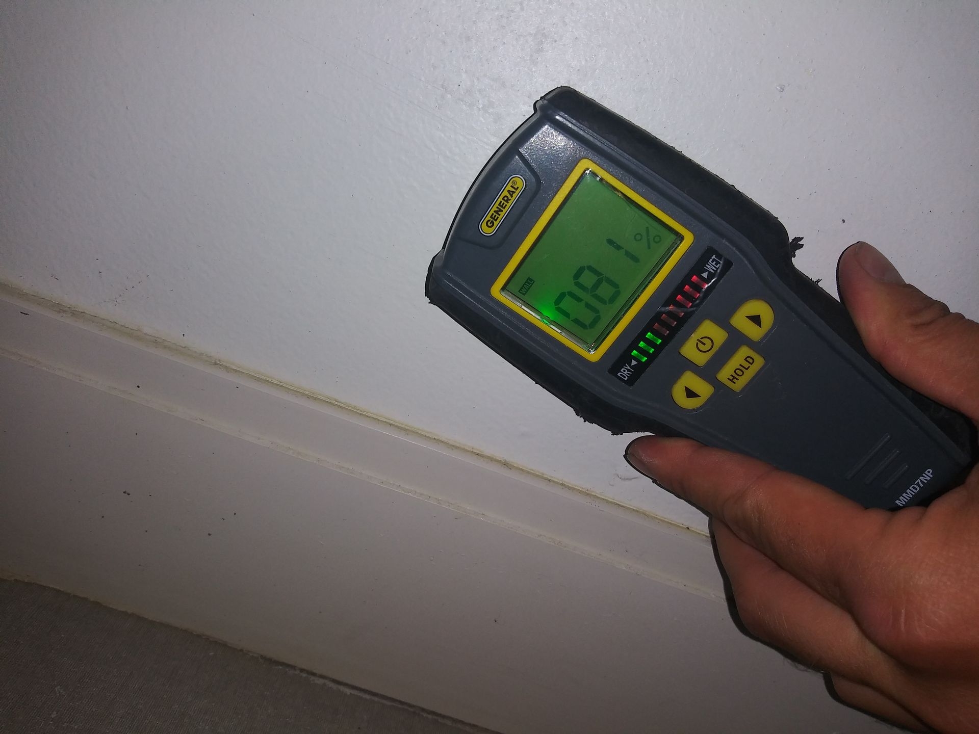 A person is holding a device that shows the time as 08.1