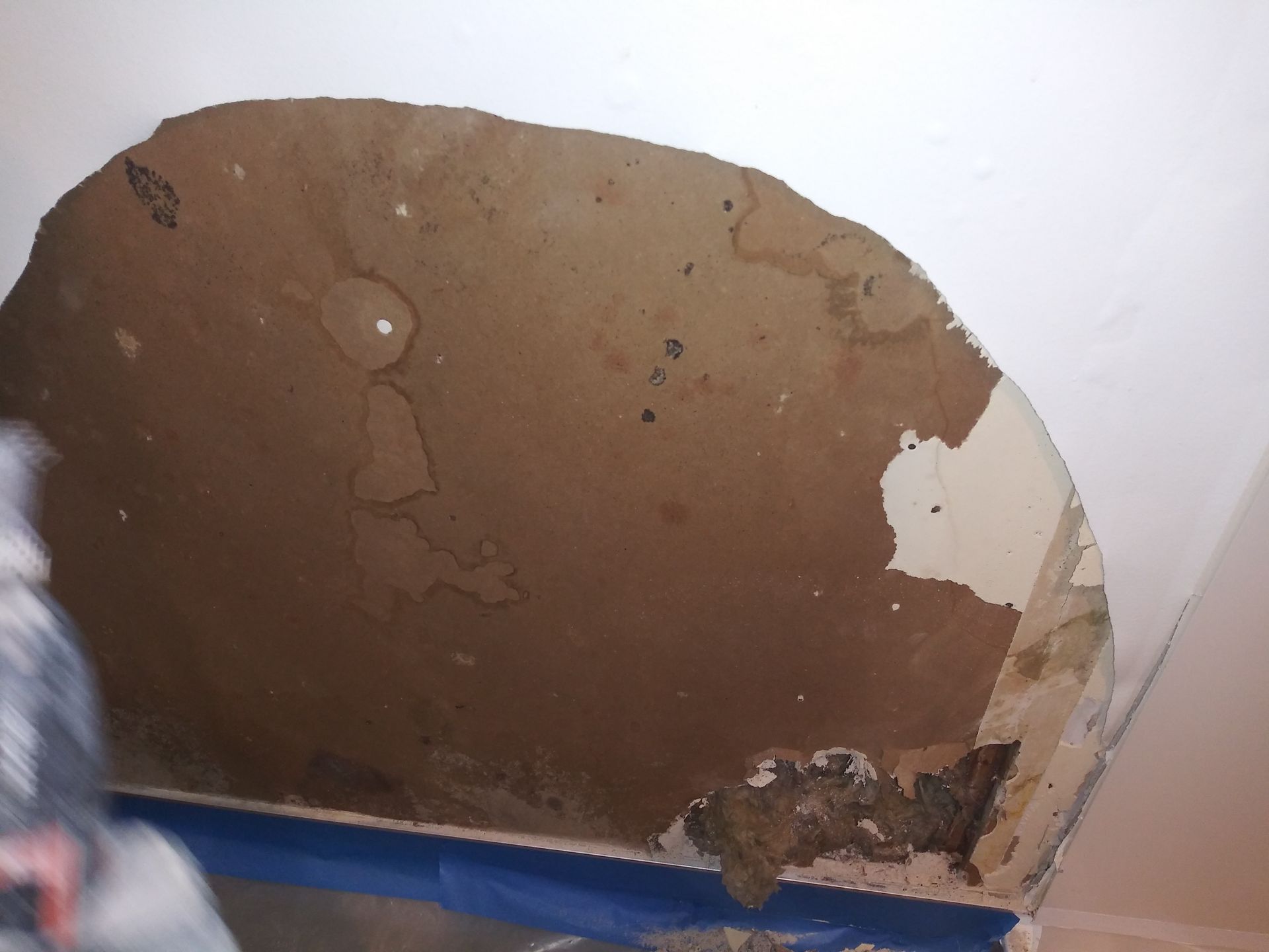 A piece of brown paper with a blue tape around it