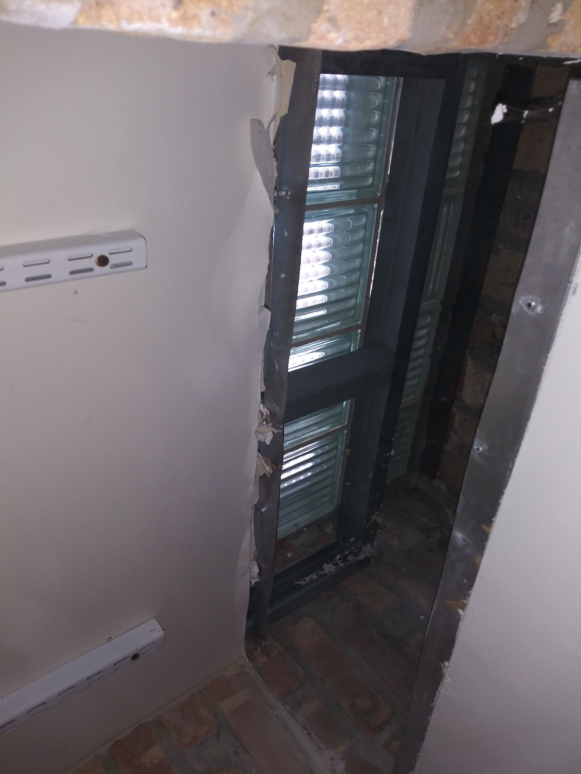 A room with a door and a window with blinds on it.