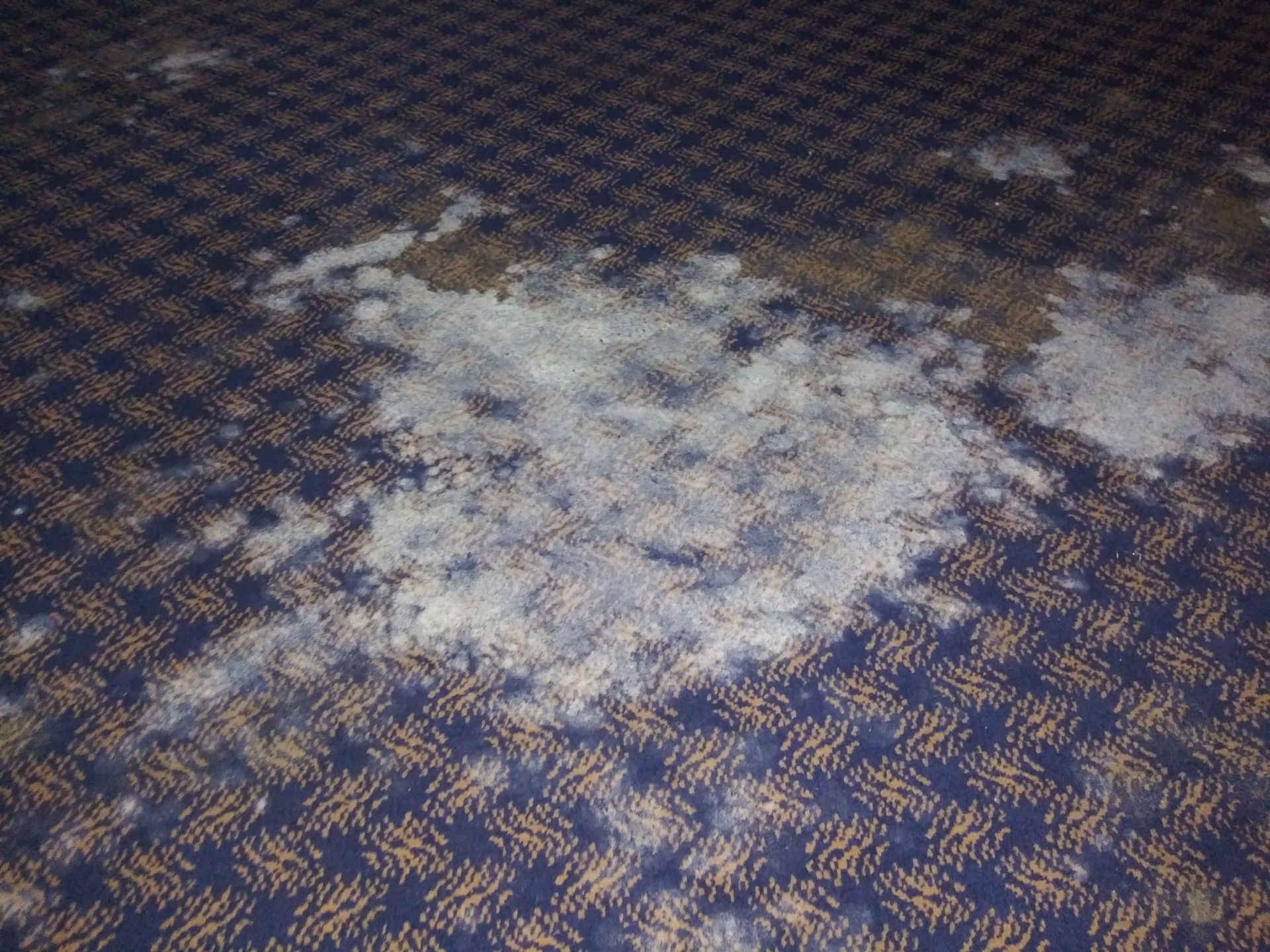 A blue and gold checkered carpet with white spots on it