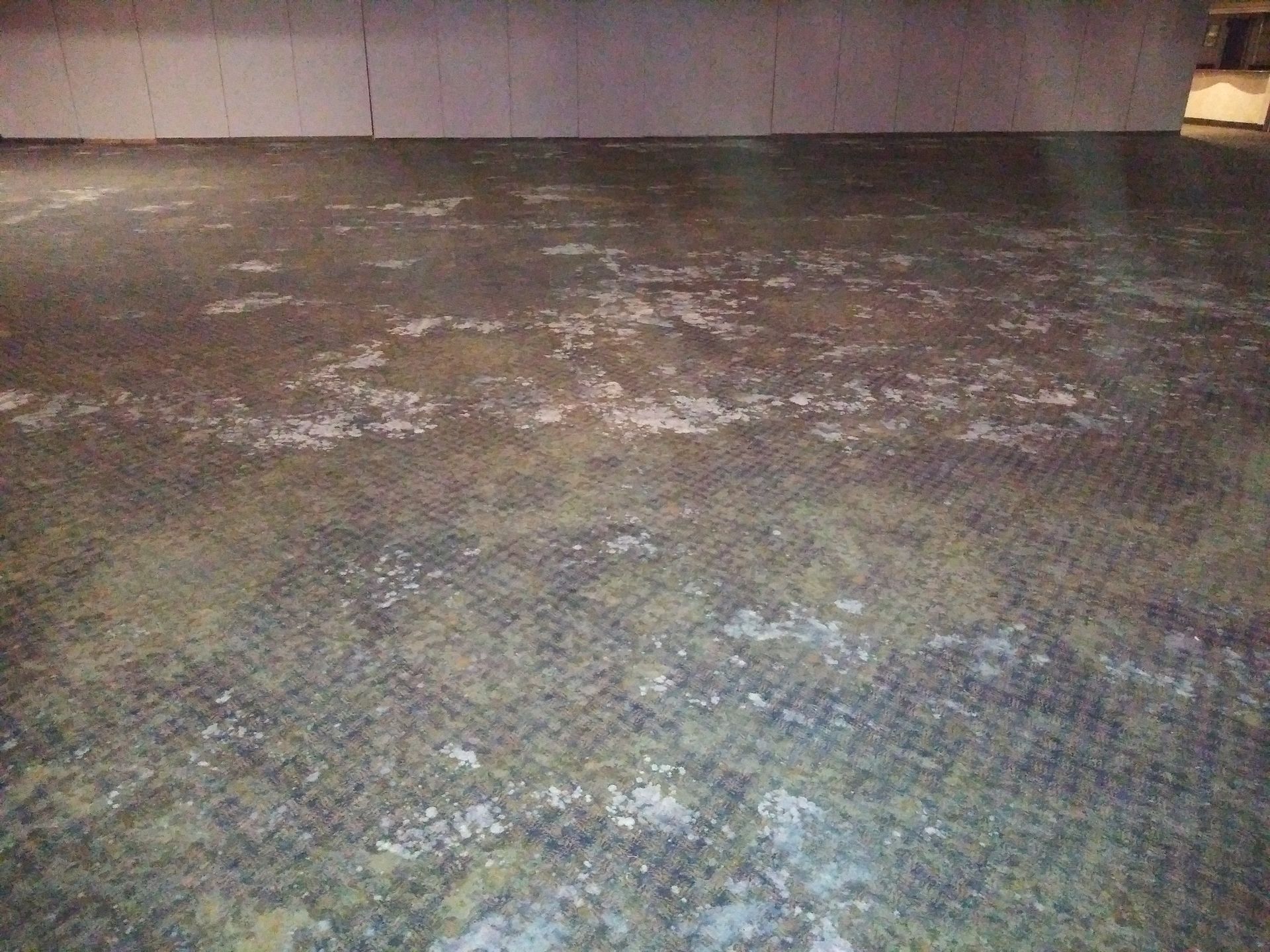 A dirty concrete floor with a lot of stains on it.