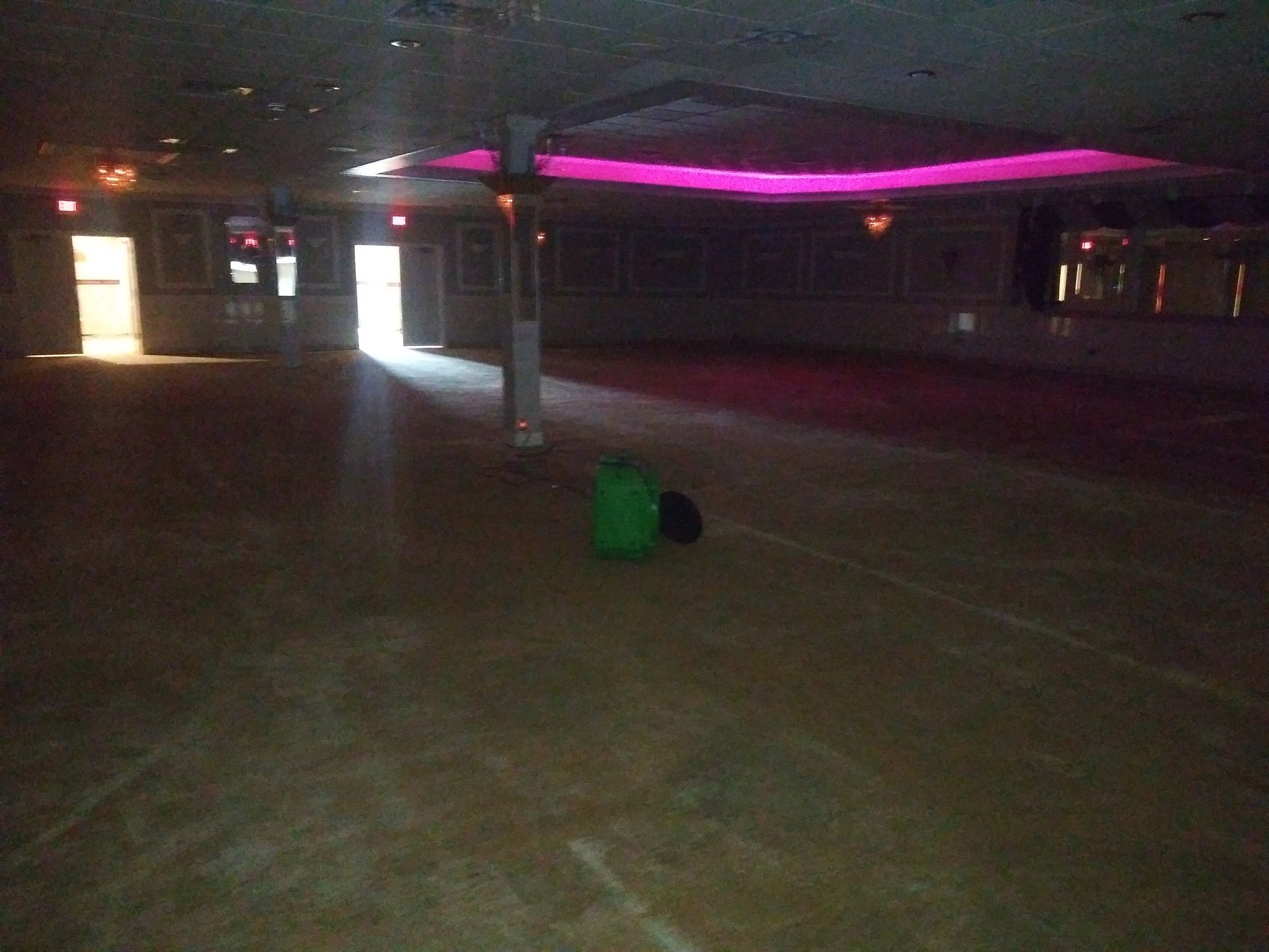An empty room with a green bag on the floor
