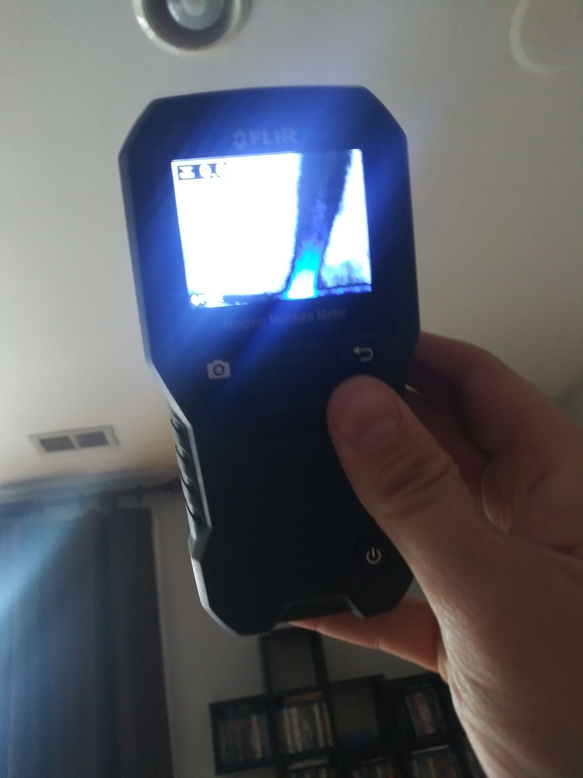 A person is holding a flir camera in their hand