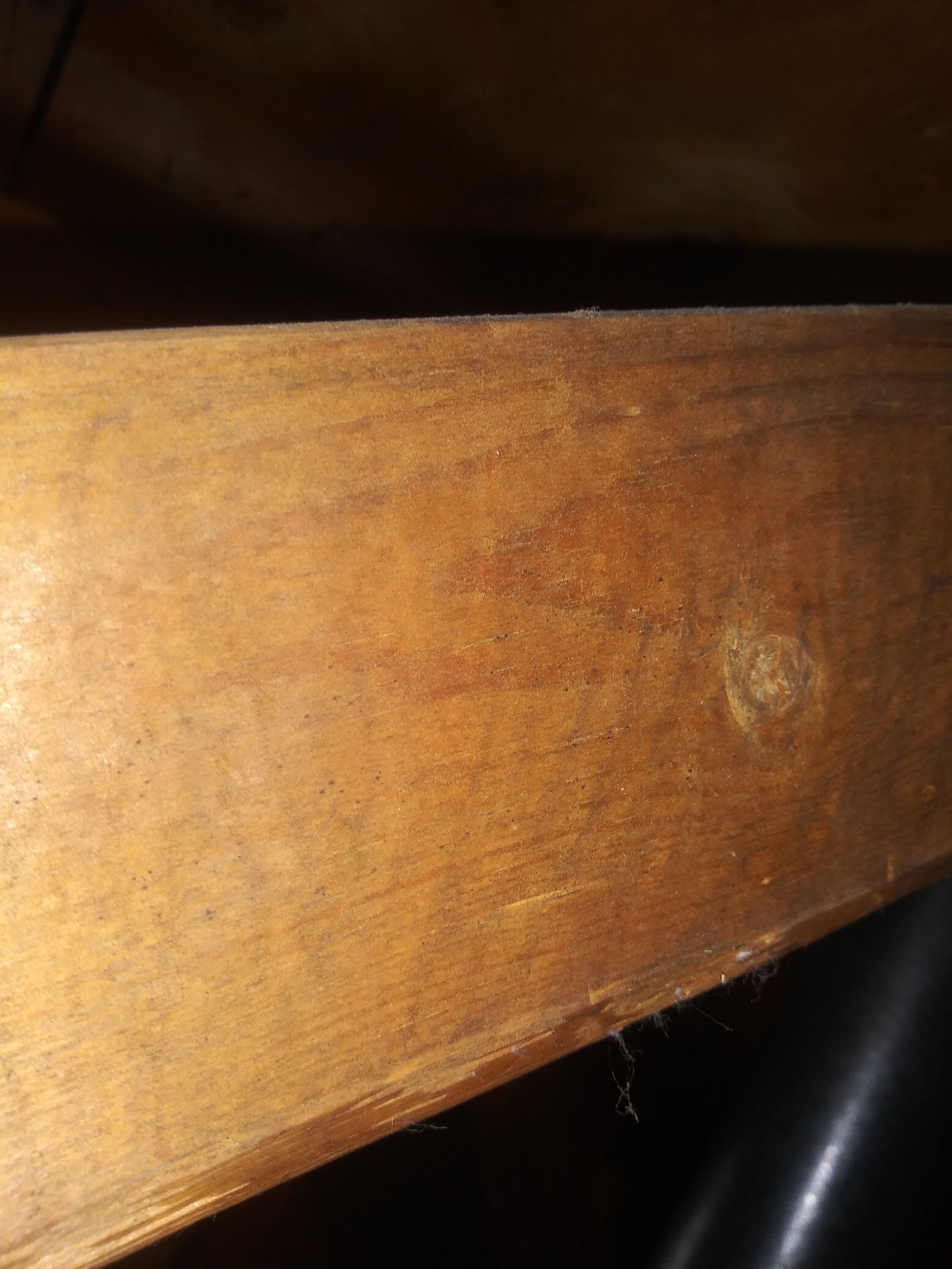 A close up of a piece of wood with a hole in it.