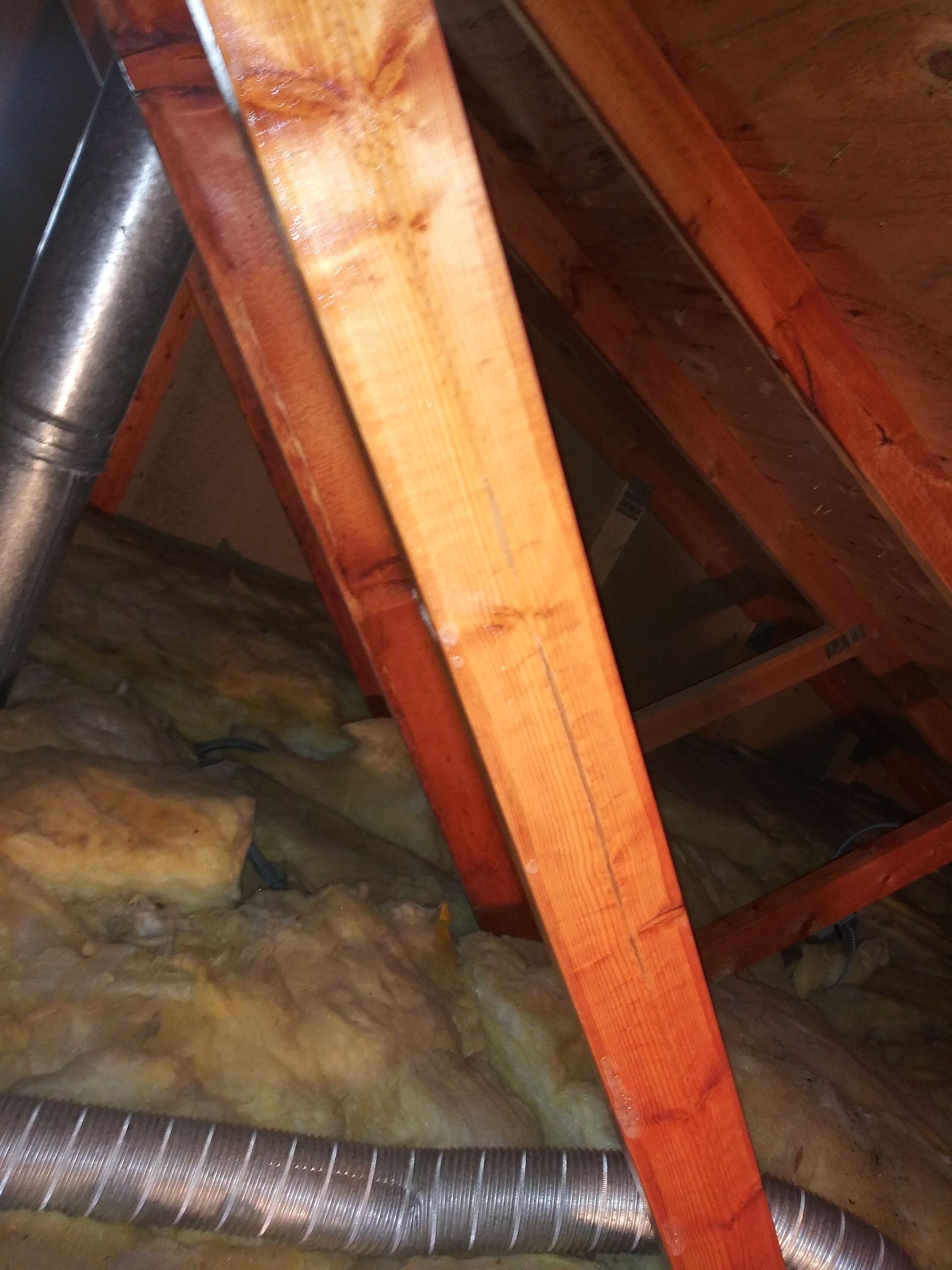 A wooden structure with a metal pipe going through it.