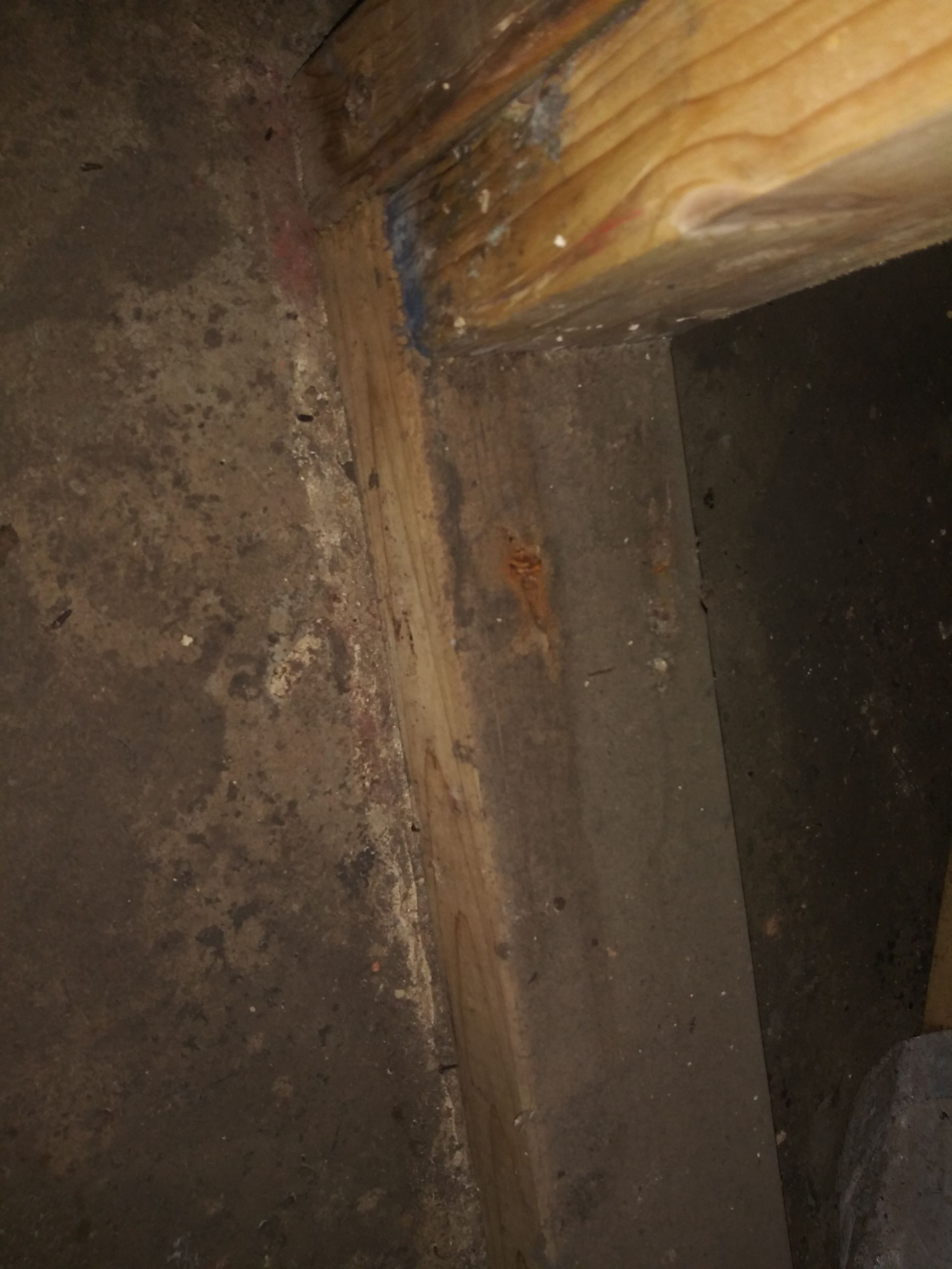 A close up of a wooden beam in a dark room.