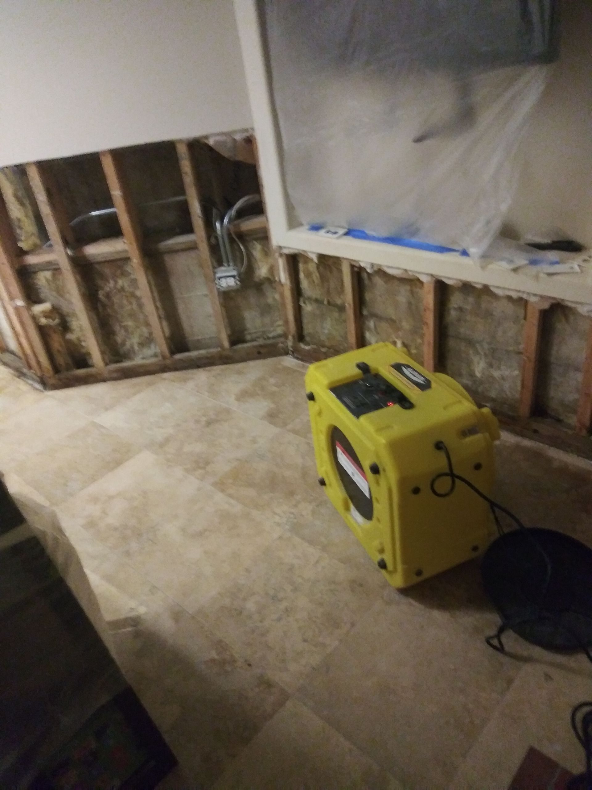 A yellow box is sitting on the floor in a room.