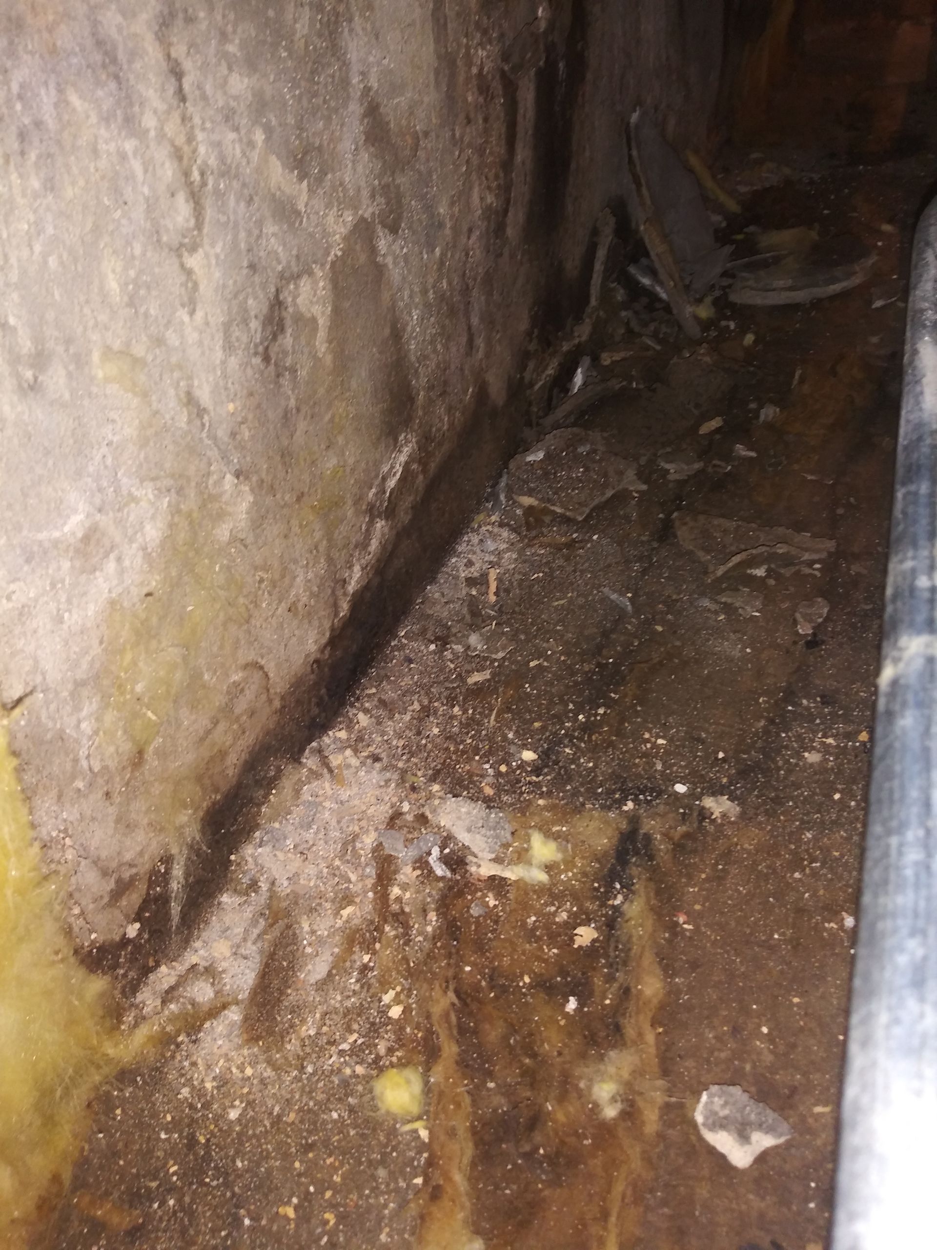 A close up of a hole in a wall in a basement.