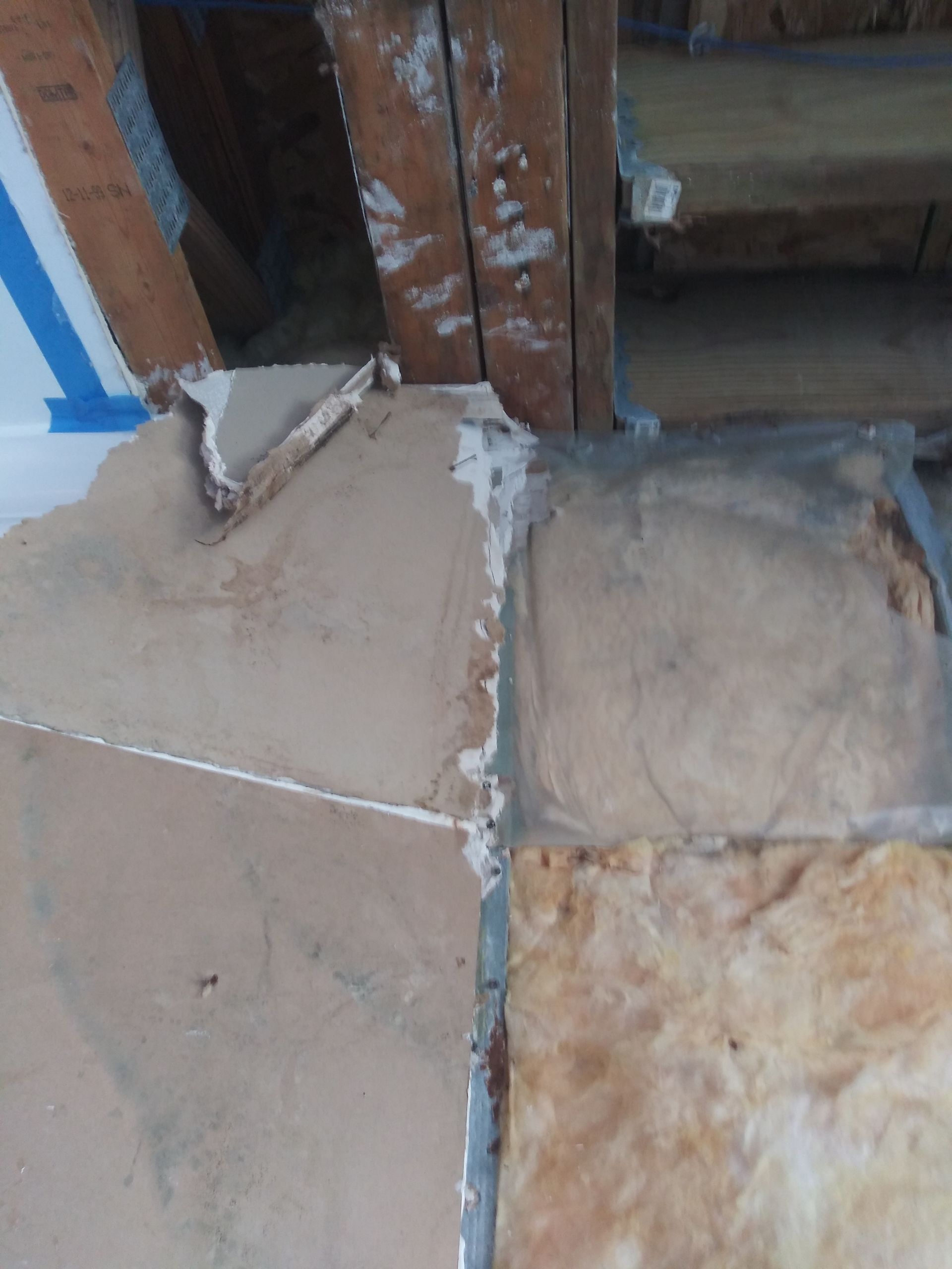 A piece of cardboard is laying on the floor next to a wall.