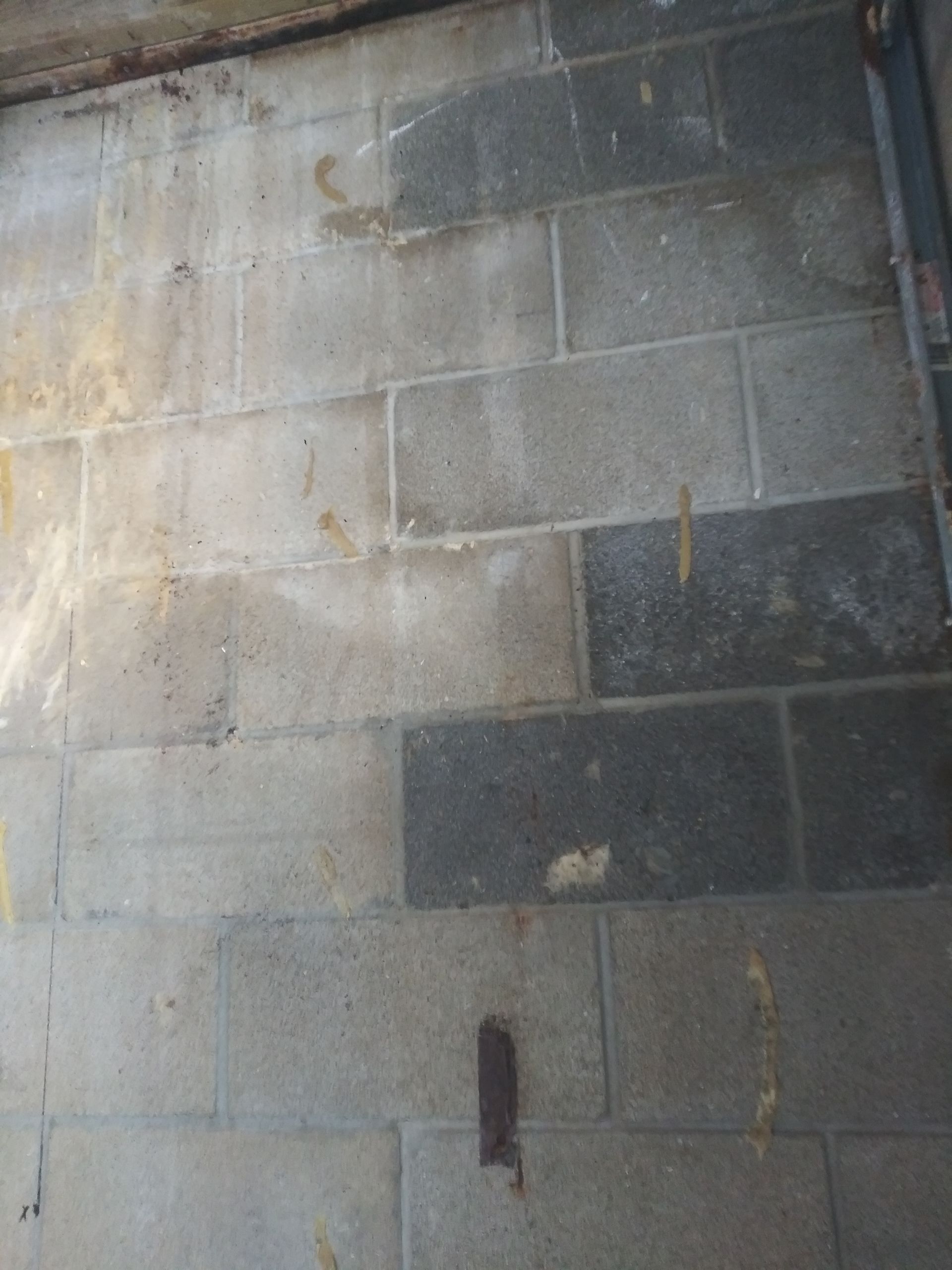 A close up of a brick floor with a few stains on it
