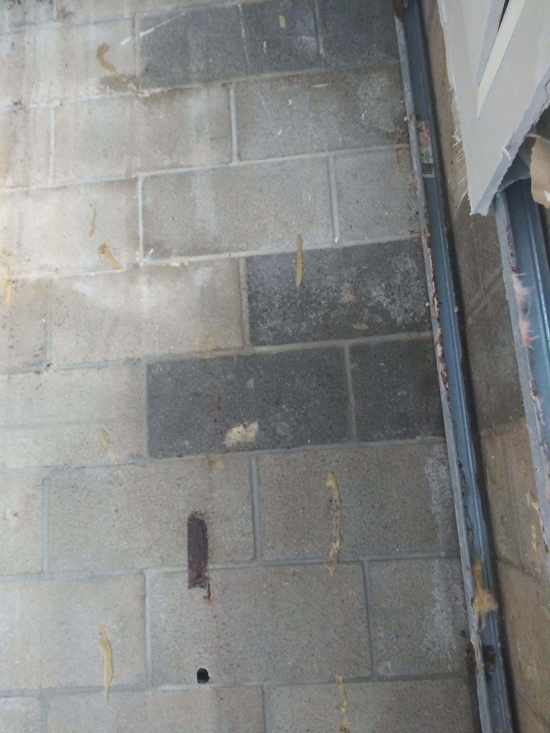 A close up of a brick floor next to a window