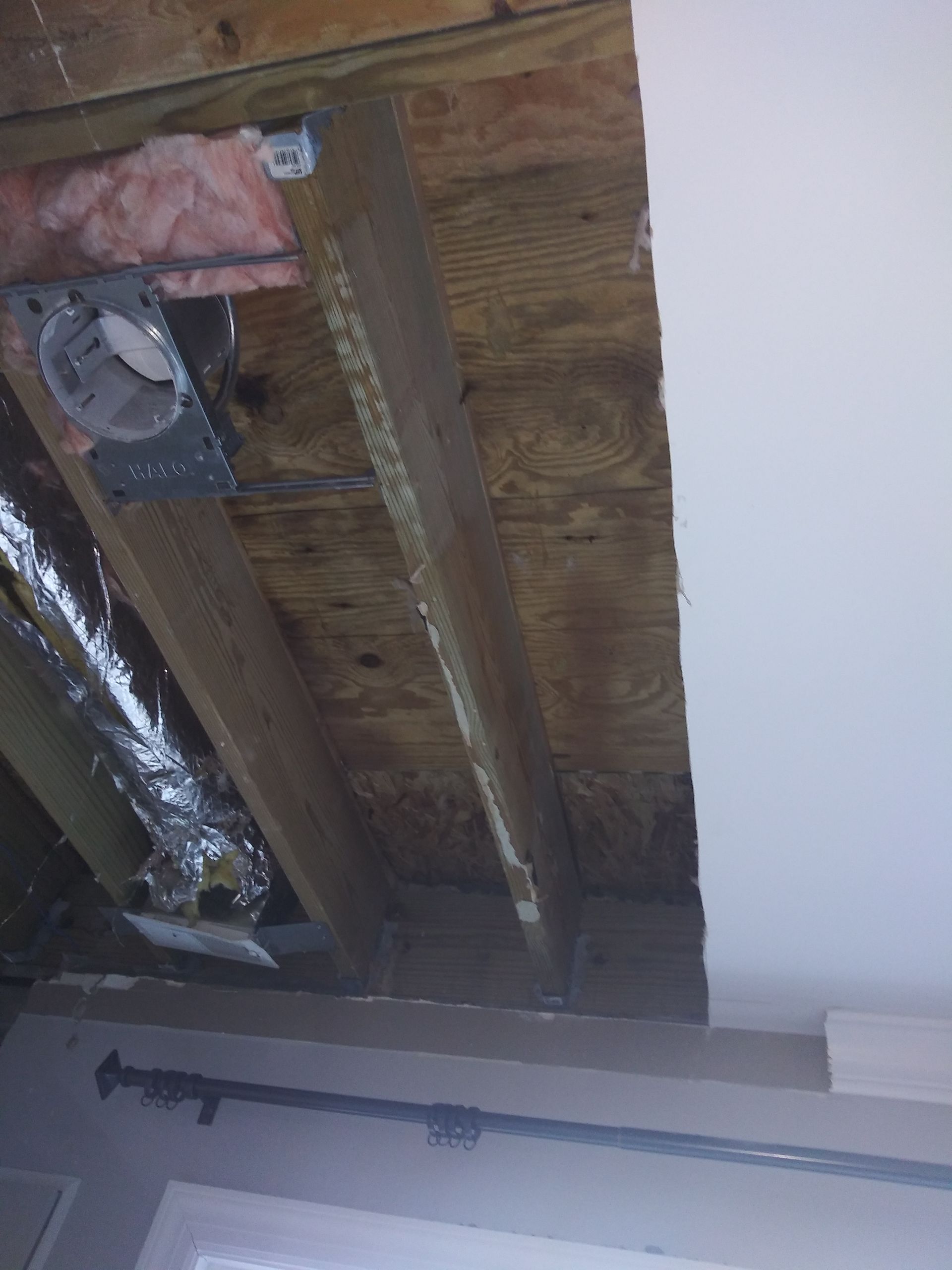 A picture of a ceiling with a fan coming out of it.