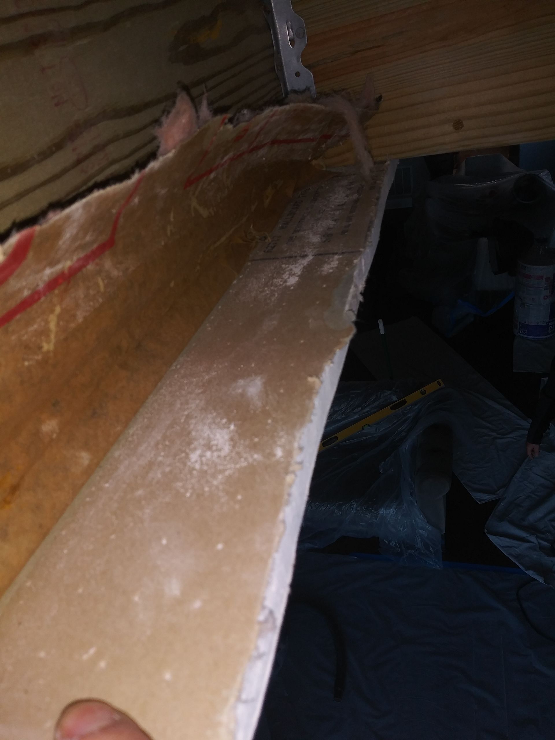 A person is holding a piece of wood in their hand.