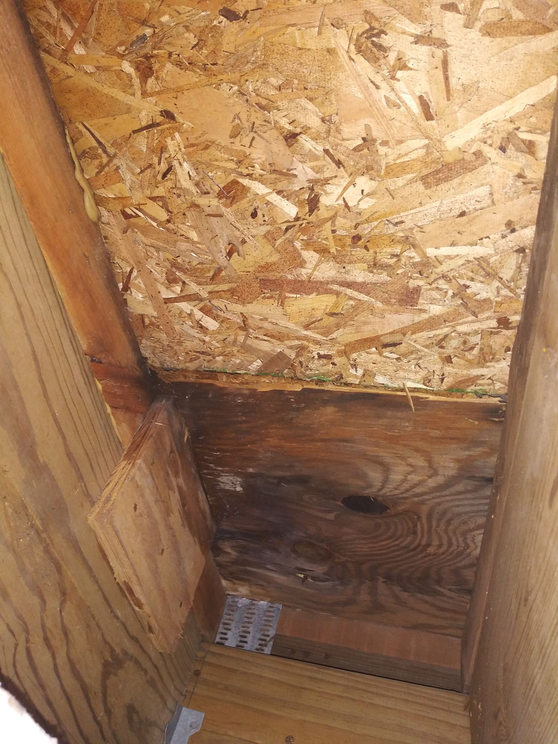 There is a hole in the ceiling of a wooden building.