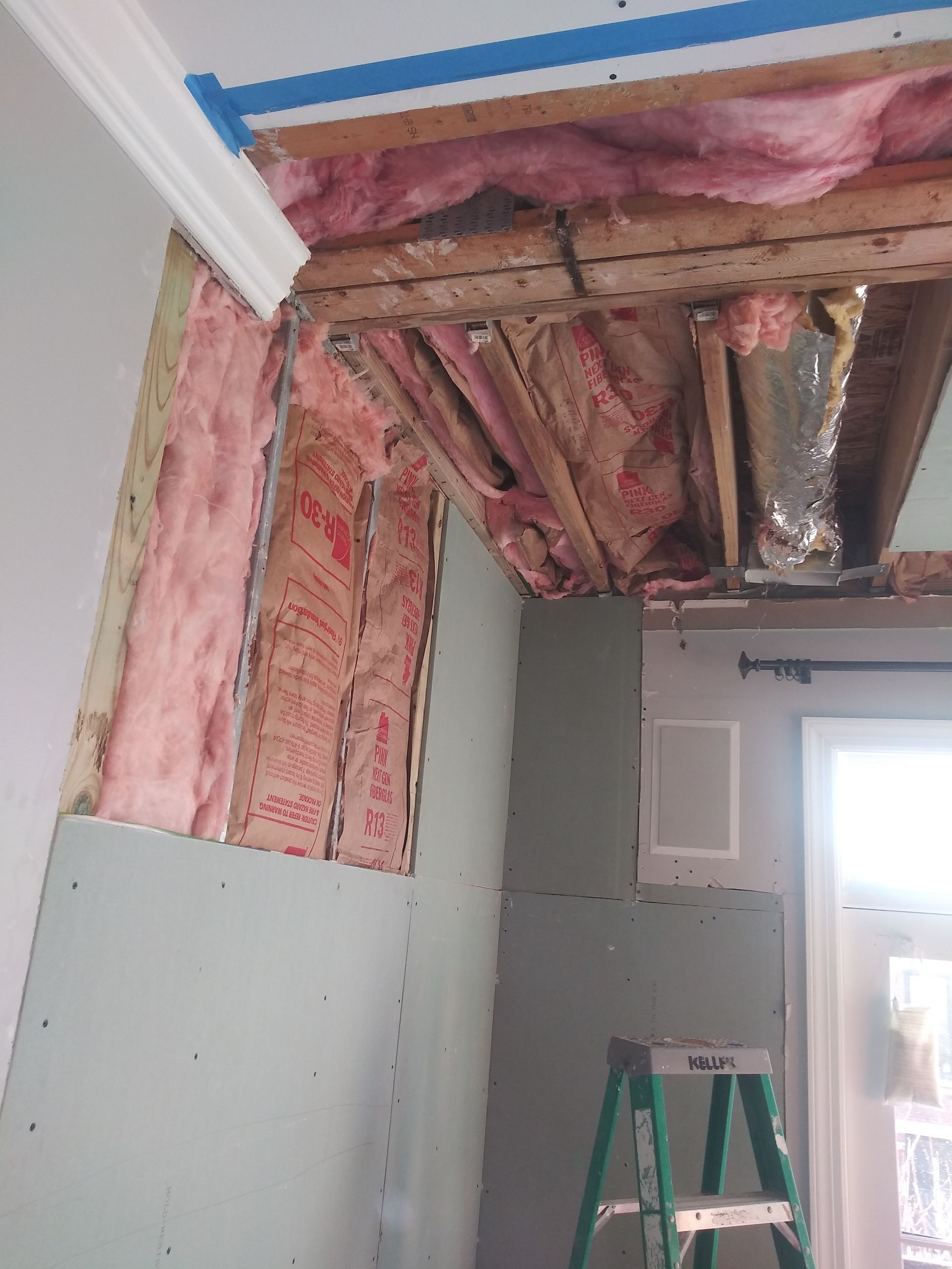 A room under construction with a ladder in the corner.