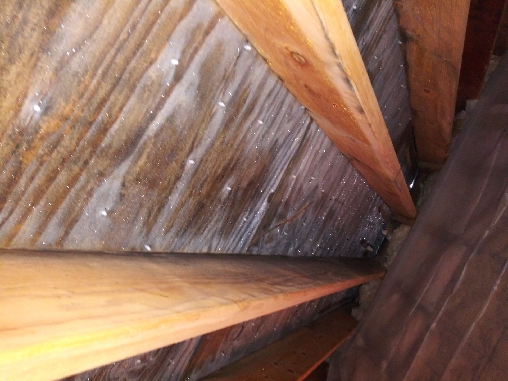 A close up of a wooden ceiling with a lot of wooden beams.