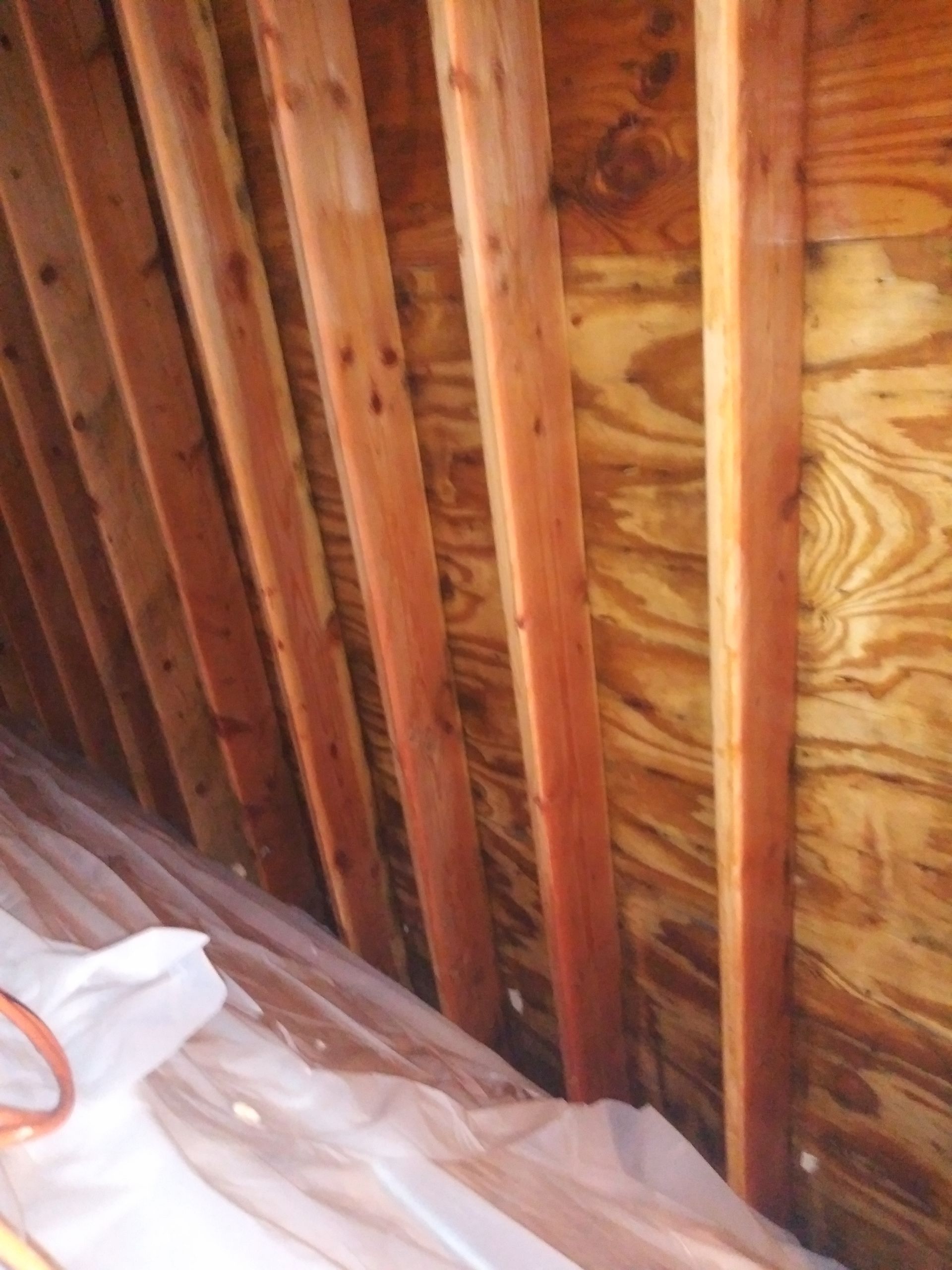 A close up of a wooden structure with plastic covering the floor