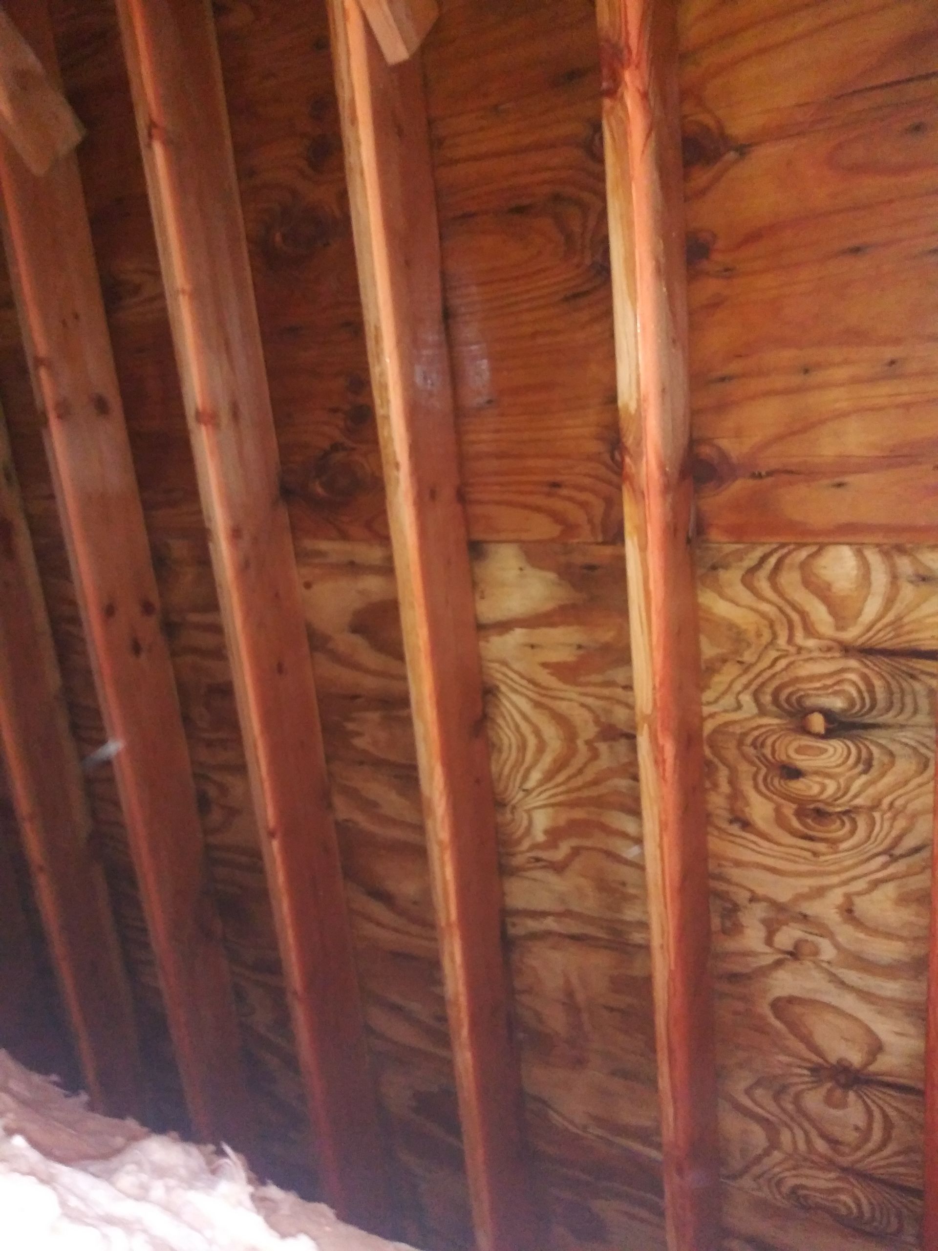 A close up of a wooden ceiling with wooden beams.