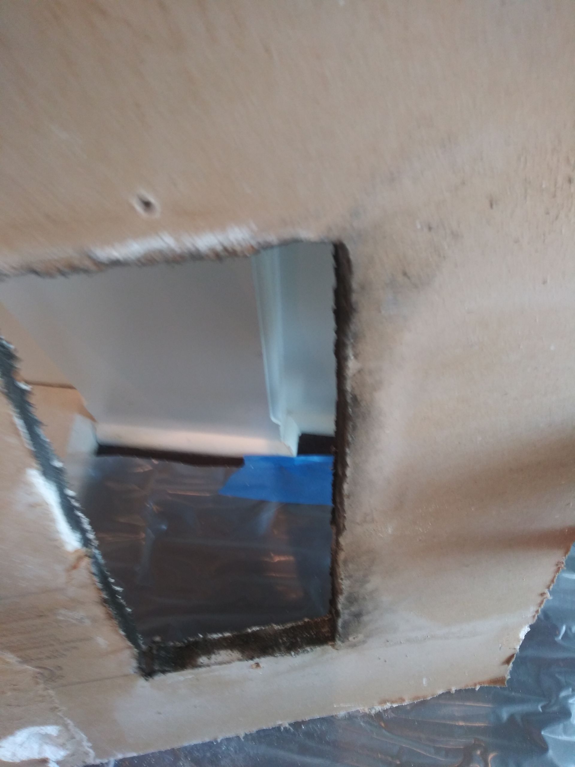 There is a hole in the wall that looks like a doorway.