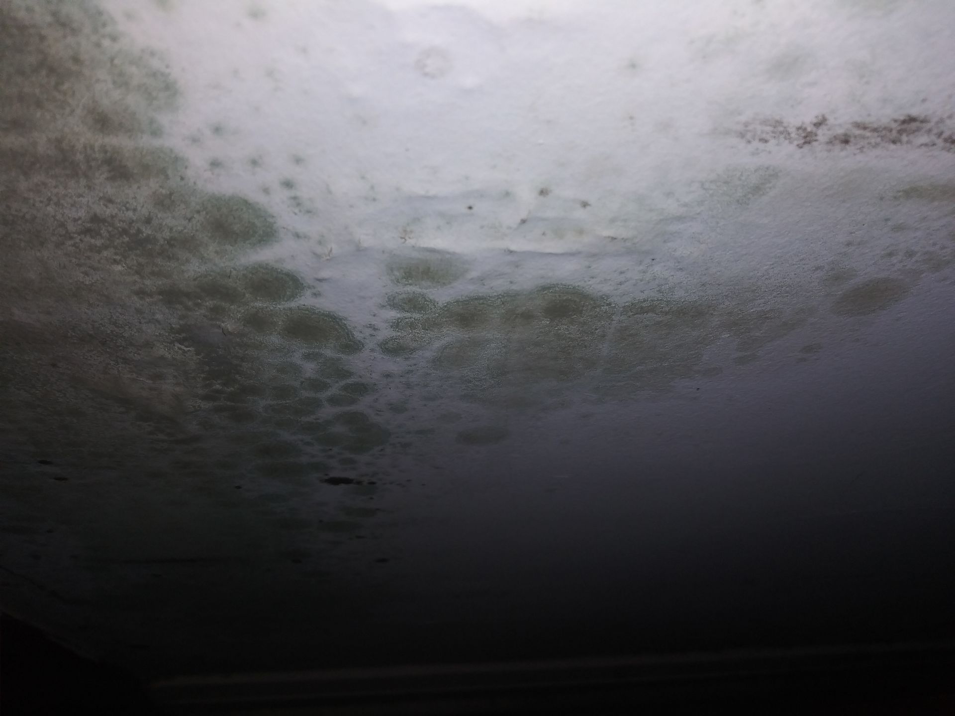 A close up of a gray surface with a lot of bubbles on it.