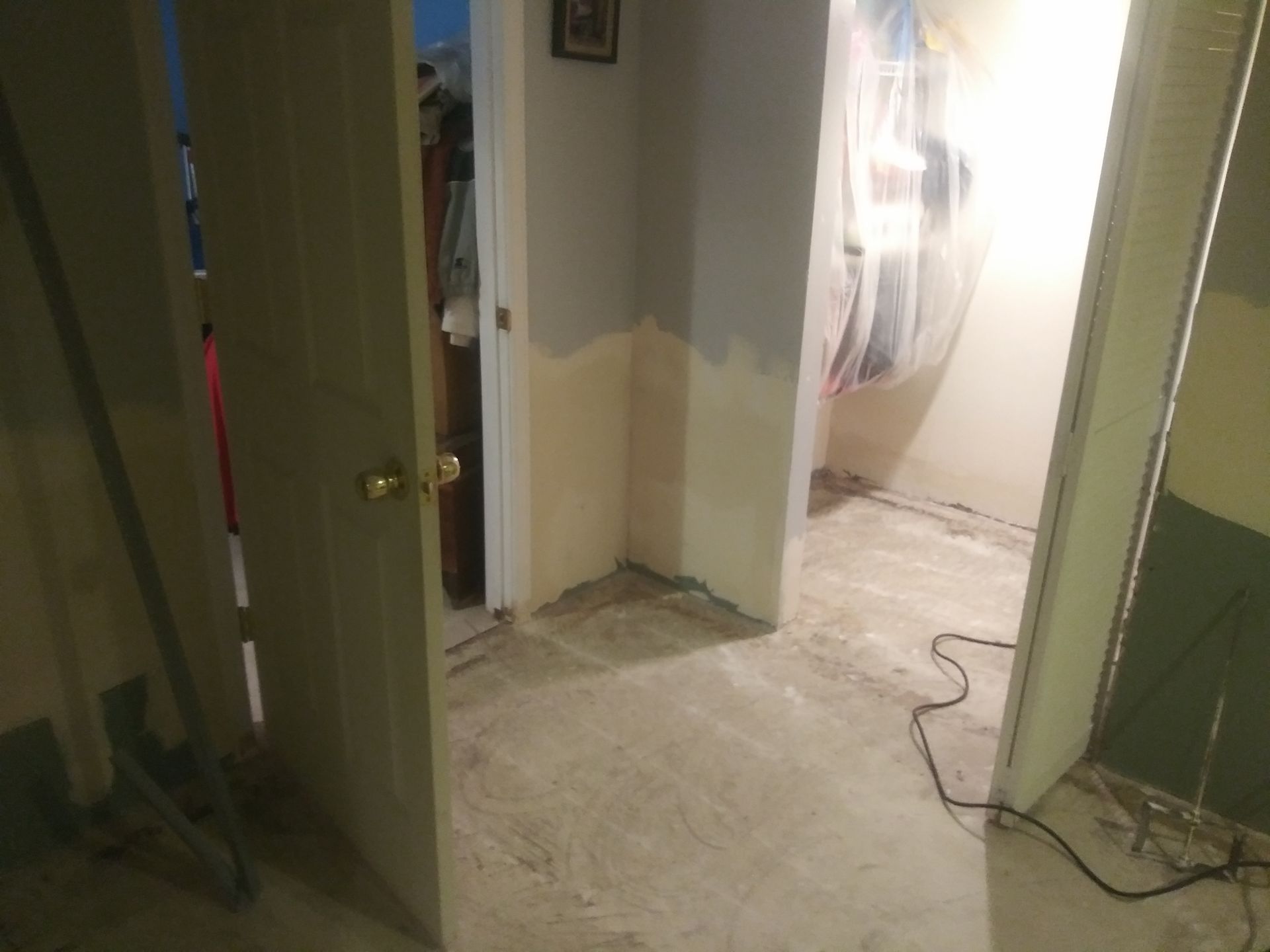 A room with a door open and a carpeted floor.