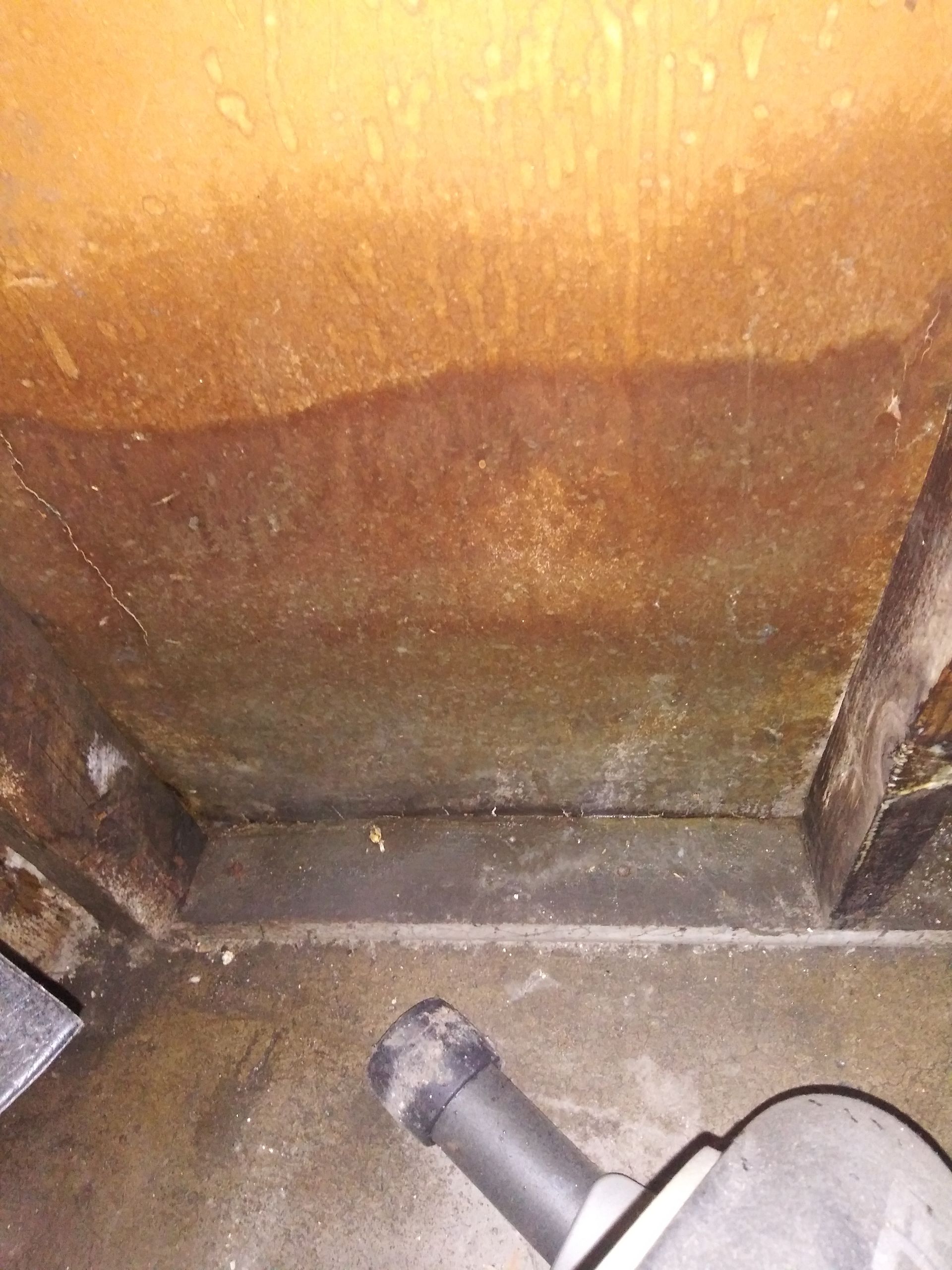 A close up of a piece of metal on a concrete floor.