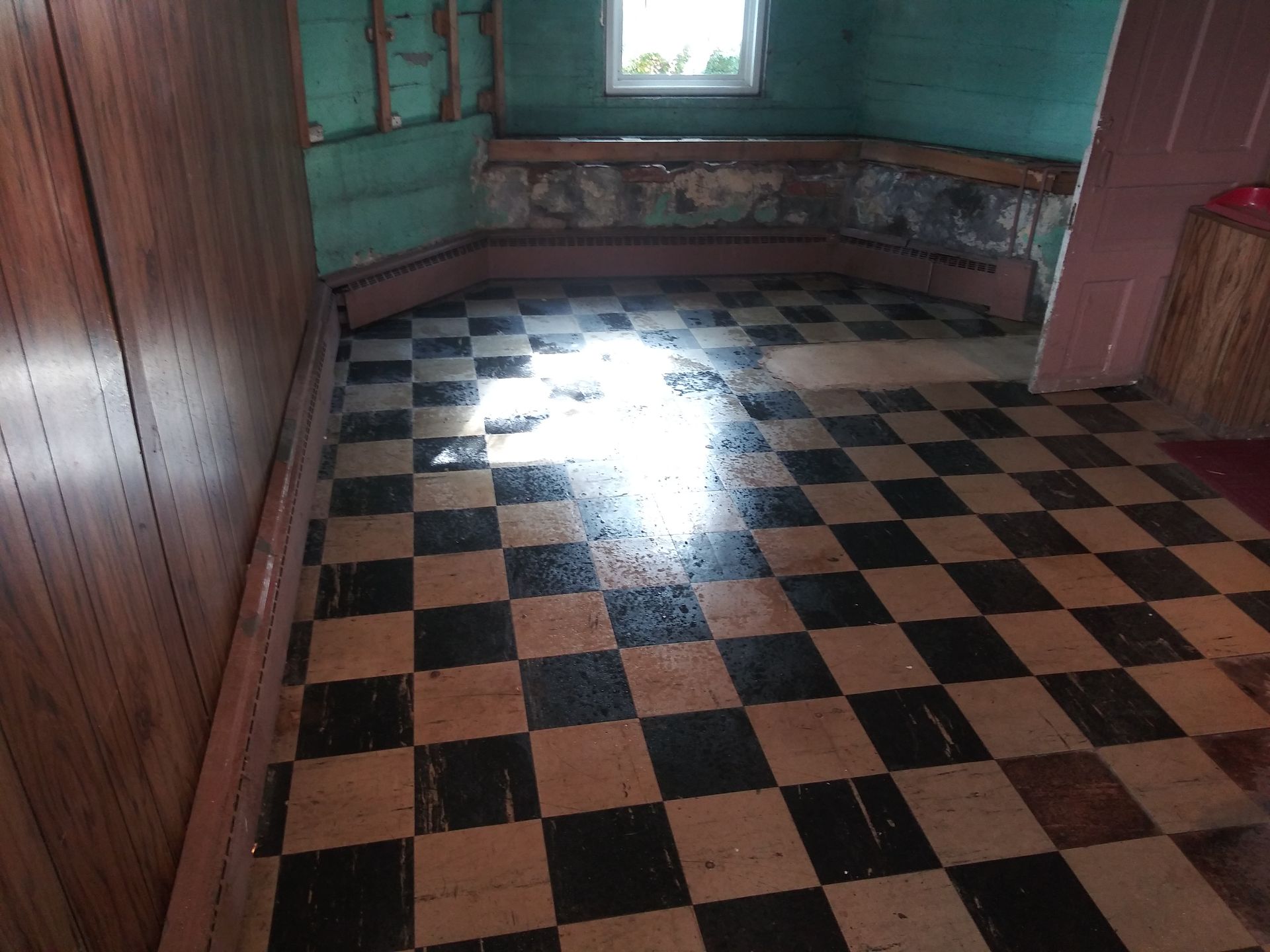 A room with a checkered floor and a window