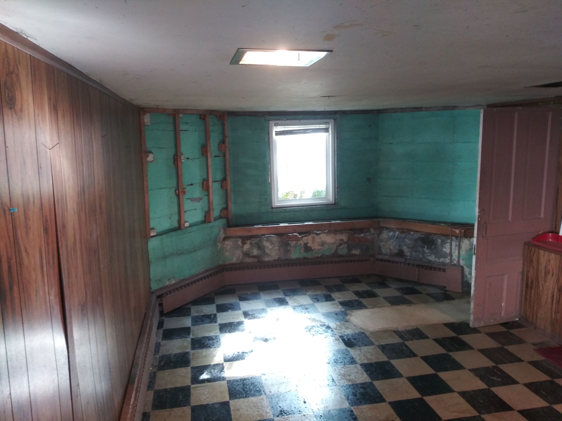 A room with a checkered floor and a window