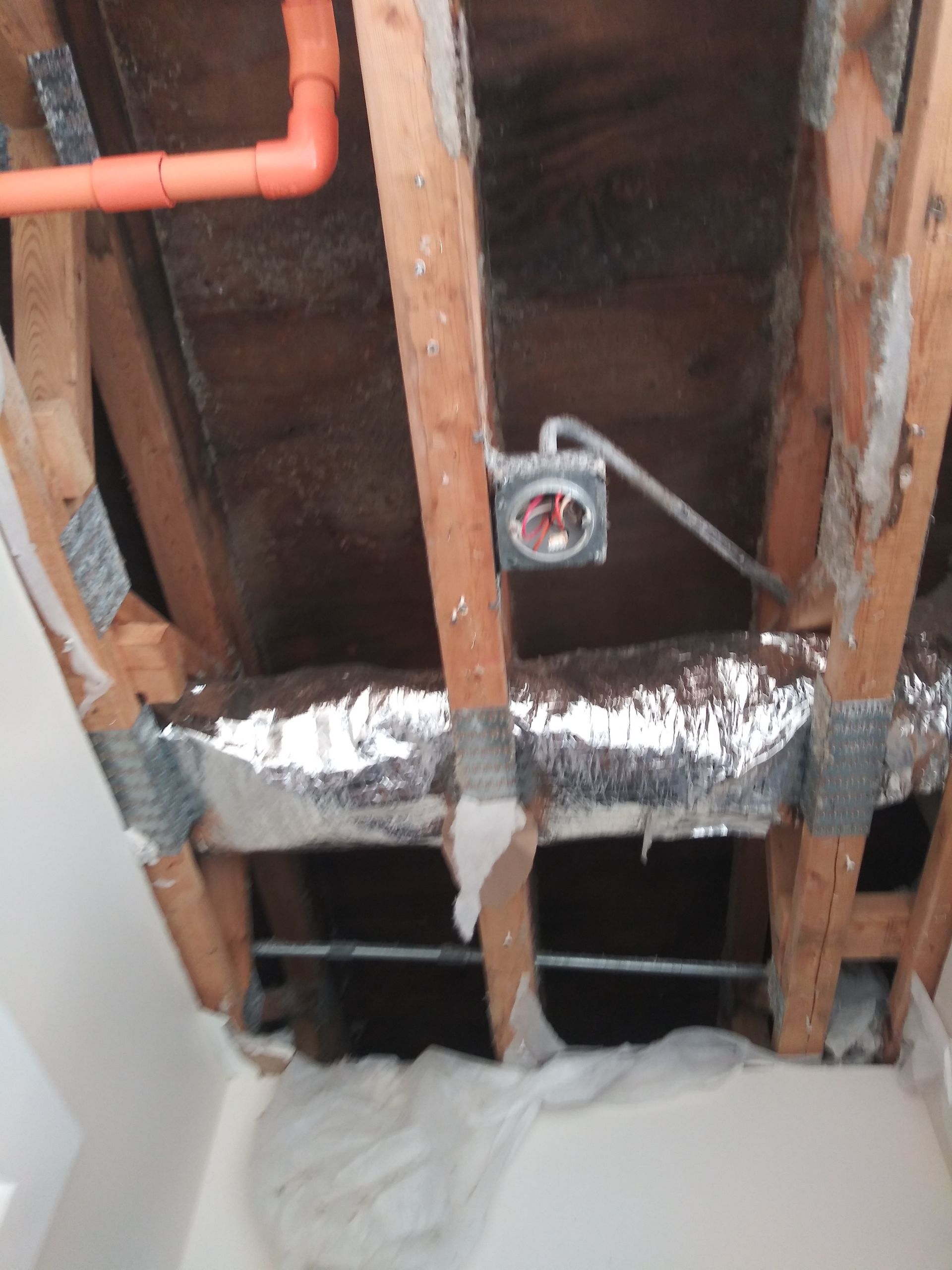 A ceiling with a few pipes hanging from it