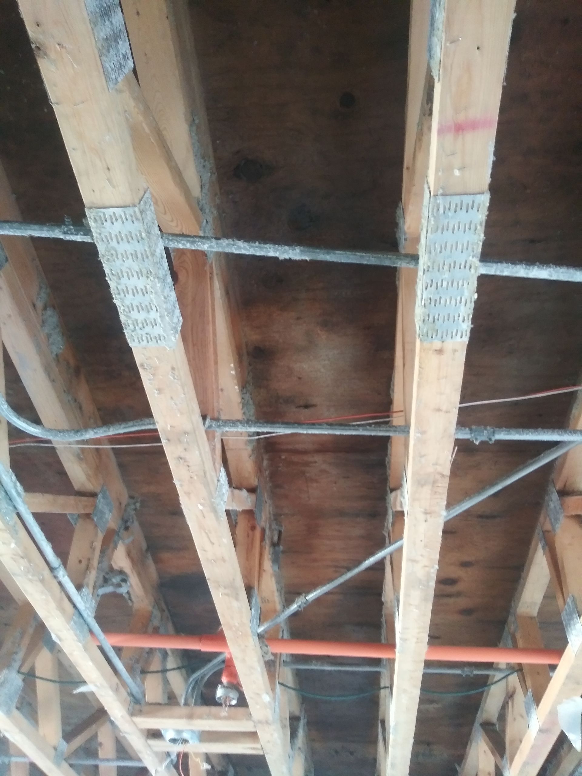 A wooden structure with a lot of wires hanging from it