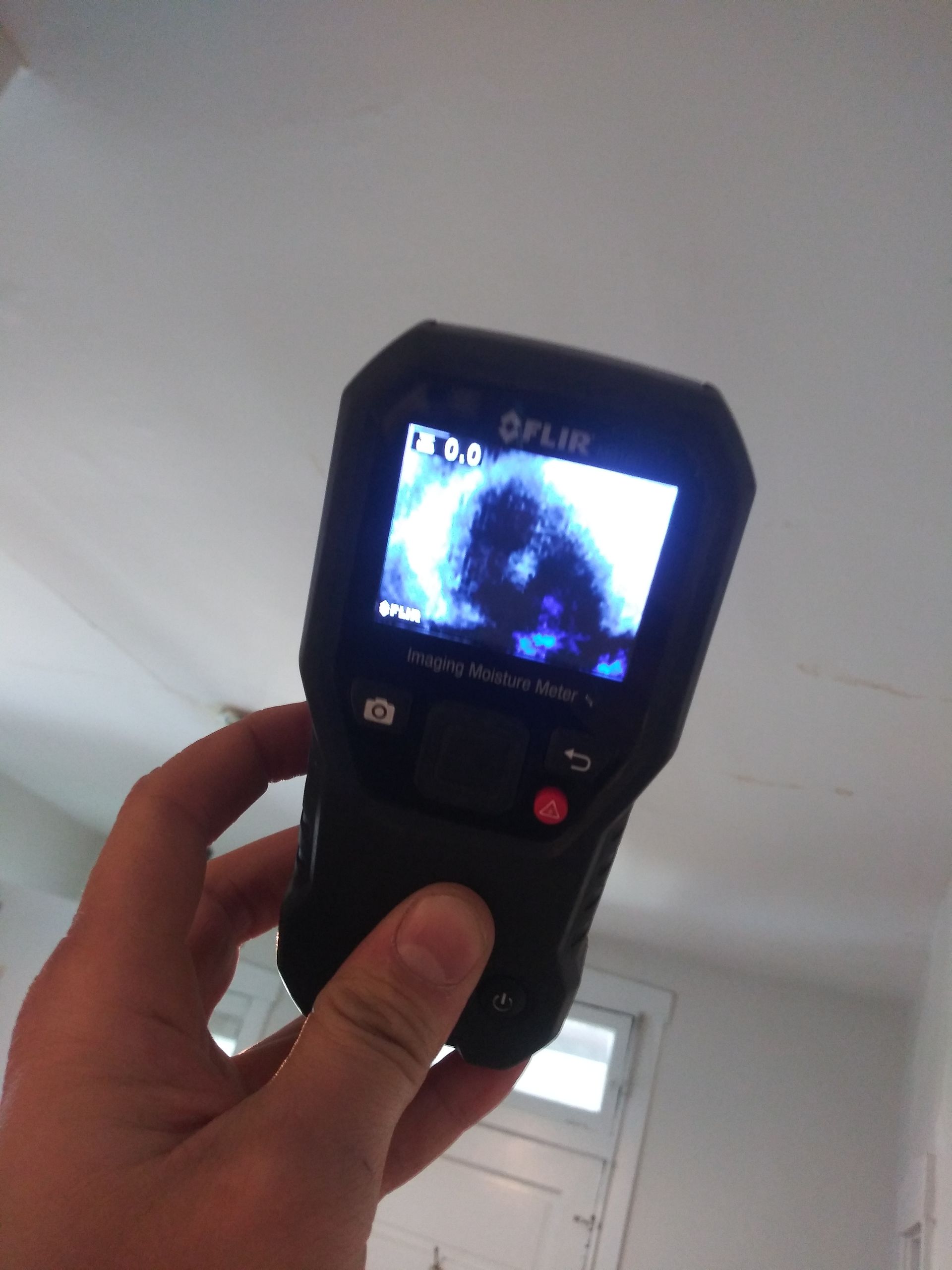 A person is holding a flir camera in their hand