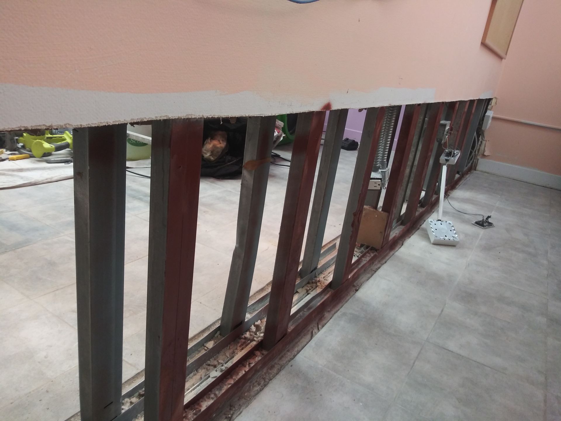 A metal railing is being built in a room