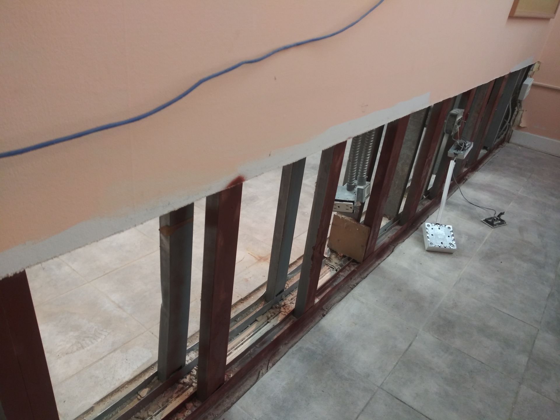 An aerial view of a building under construction with a vacuum cleaner on the floor