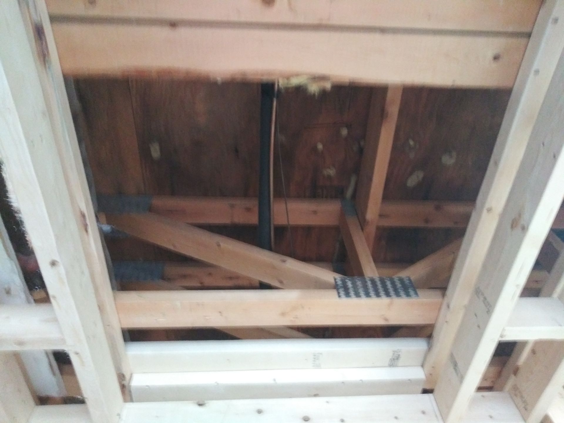 A wooden structure with a pipe in the middle of it