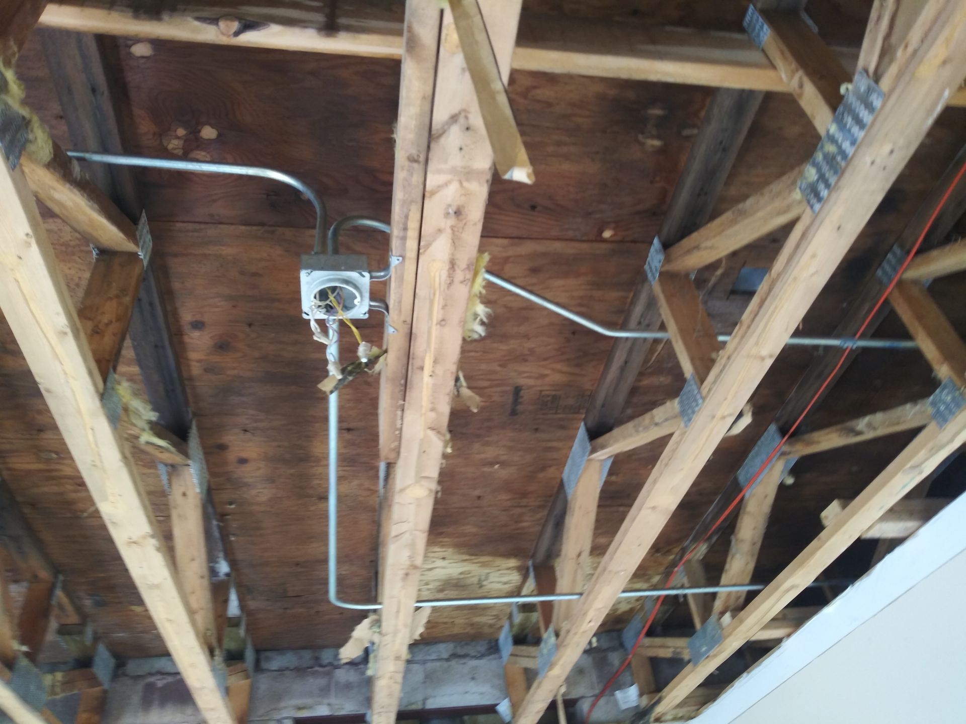 A ceiling with a few wires hanging from it